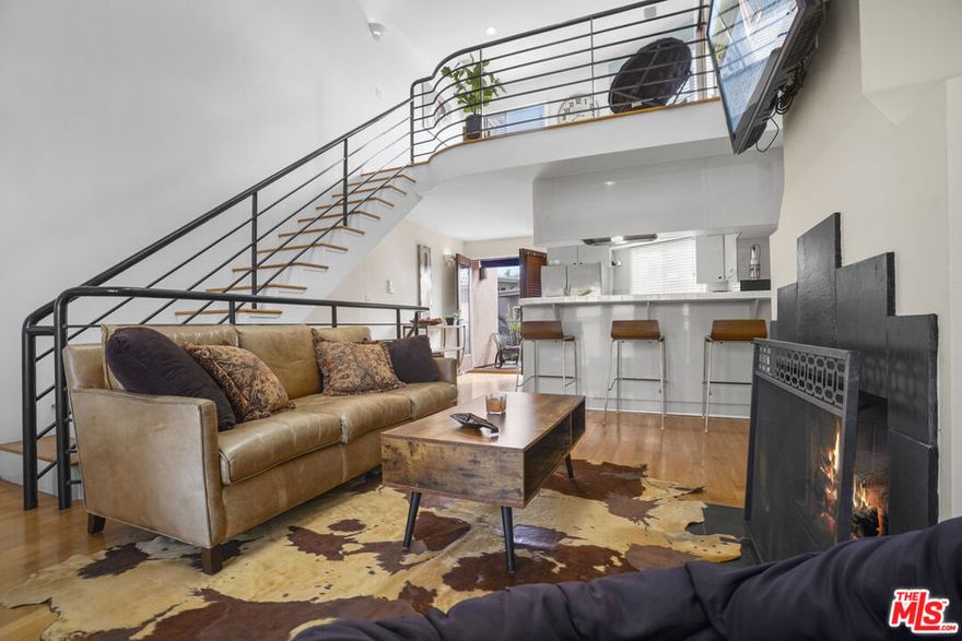 Just two blocks from Main Street and a short stroll to the sand, this architectural two-bedroom + loft townhome designed by famous architect Barbara Coffman & Associates captures the essence of a modern beach-city pad - bright, open, and easy. Vaulted ceilings, double skylights, and oak hardwood floors create a light-filled living space that opens to a sunny patio perfect for coffee, alfresco dinners and Ocean Views! The open-plan kitchen and living room blend clean design with practical comfort, while a gas/log fireplace adds warmth and atmosphere on cooler coastal nights. Bathrooms have been updated with modern, clean finishes and palette. Freshly painted throughout. New shaker-style wood and frosted glass doors and custom shutters deliver that inviting SaMo condo feel while capturing natural light. Upstairs, the loft with Palos Verdes and Malibu views offers a versatile retreat ideal for a home office, creative studio, or evening wind-down spot. Every room connects to the outdoors with a private balcony or patio, letting in natural light and ocean breezes through brand-new French doors off every balcony. With side-by-side gated 2 car parking, huge storage, in-unit laundry, central A/C, and low HOA dues, this home is as functional as it is inviting. Step outside and you're minutes from Urth Caffe, the Sunday Farmers Market, Rose Ave, yoga studios, boutiques, and everything that makes Ocean Park the most desirable neighborhood in Santa Monica and top 3 in all of US. The six-residence complex has a quiet, community feel, tucked right in the heart of Santa Monica's most desirable neighborhood. The complex just finished a major $350K+ capital renovation with replaced sewer, stringers, decks, exterior repairs and full painting, brand new French doors and no outstanding assessments. Whether you surf, work from home, or just love being close to it all, this is the kind of place that makes that dream lifestyle a reality.