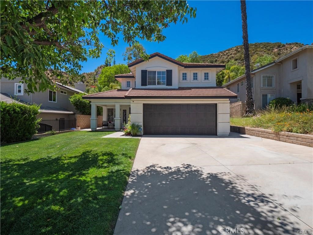 Exquisite 4-bedroom Pool Home in Castaic, situated on a nearly 10,000 sq ft lot with NO HOA fees. Nestled in a charming neighborhood, this residence greets you with a welcoming front porch and a bright, open floor plan featuring soaring ceilings and abundant natural light. The formal living and dining areas flow seamlessly into the kitchen and family room, where a cozy fireplace and views of the lush backyard create the perfect setting for gatherings. A convenient laundry area and guest powder room complete the main level. Upstairs, the spacious primary suite offers high ceilings, a large walk-in closet, and an en-suite bath with dual sinks and vanity area. Three additional bedrooms and a full bath provide plenty of room for family or guests. The private backyard is designed for relaxation and entertainment, highlighted by a sparkling pool and spa. Enjoy the proximity to Castaic Lake and Recreation Area, scenic hiking and biking trails, shopping, dining, and quick freeway access—ideal for commuters. Don’t miss the opportunity to make this beautiful home yours!