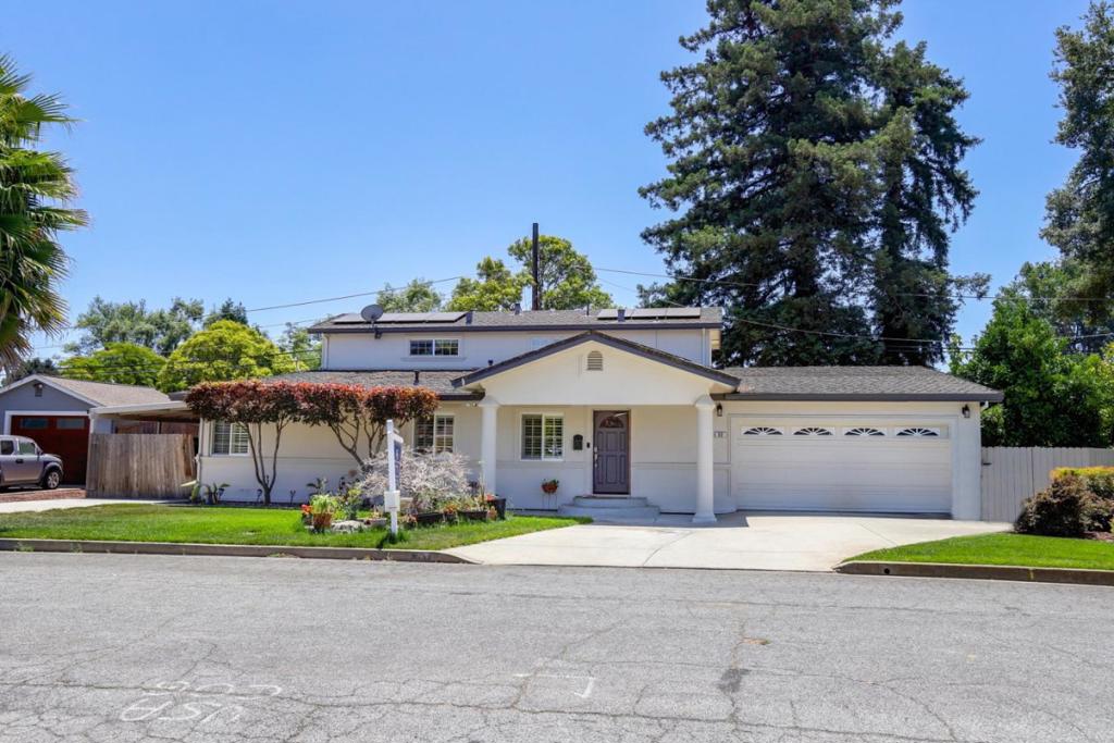 Welcome to this charming home on a tree-lined street in desirable Gilroy neighborhood, which offering 4 spacious bedrooms, 2.5 baths, and nearly 3,100 square feet of comfortable living space. Perfectly situated on a generous 9,025 SF lot, it boasts a unique layout with two bedrooms and a full bath conveniently located on the main floor. The heart of the home is the expansive kitchen ideal for entertaining with cherry cabinetry, granite countertops, center island, stainless steel appliances, and a walk-in pantry. The primary suite is a relaxing retreat featuring slate finishes, dual shower heads, and a luxurious sunken tub. Outside, the backyard is a true showstopper-an entertainer's dream complete with a built-in BBQ, outdoor kitchen, garden space, and a large side yard perfect for pets or play. The mature trees lining the yard provide a private, serene escape. Bonus: A versatile 600 SF detached workshop perfect for an artist studio, home office, or maker's space.