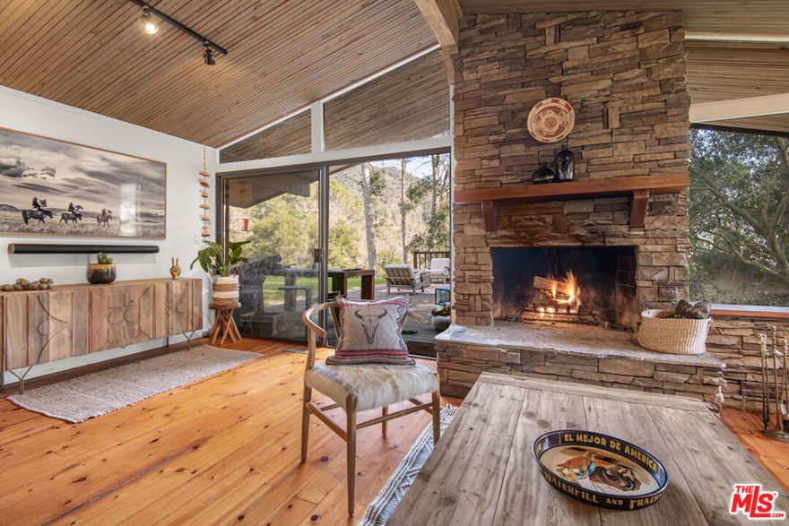 Charming Mountain Retreat in Monte Nido! Nestled in the tranquil Monte Nido community, this secluded three-story residence offers the perfect balance of privacy, natural beauty, and modern living. Situated on over half an acre within the breathtaking Santa Monica Mountains, this 3-bedroom, 3-bathroom home spans 2,251 sq. ft. and provides a peaceful retreat with panoramic mountain views.  The top floor features a gourmet kitchen flowing into a spacious dining area and inviting family room, which is centered around a cozy stone fireplace. Sliding doors lead to an expansive deck, ideal for morning yoga, coffee, or simply enjoying the sweeping mountain views as the sun rises. The private primary bedroom suite offers a large walk-in closet, an en-suite bathroom, and spectacular mountain vistas. Glass sliders open to a tranquil backyard, complete with an outdoor shower and serene landscaping, offering a true escape into nature. On the middle floor, two additional bedrooms  share a front-facing balcony and a well-appointed bathroom. The lower floor features a spacious and bright den/office with its own private outdoor entrance, making it ideal for a home office or creative space. The lower level also includes a  full bathroom and a laundry area.The property includes a 3-car garage, two spaces of which have been converted into a  guest unit, featuring a bedroom,  bathroom, and full kitchen. Behind a private gate, an expansive courtyard provides parking for several cars, plus room for your recreational vehicles and toys.The tiered backyard offers endless possibilities, with ample room for a pool and gardening. With sweeping views of the mountains, this serene outdoor space is perfect for relaxation and entertaining. Enjoy direct access to the famous Backbone Trail, with dedicated hiking and horseback riding trails nearby, immersing you in the natural beauty of the Santa Monica Mountains.  Just a short drive to Malibu and The Commons in Calabasas, you'll enjoy the peace and quiet of Monte Nido while being close to shopping, dining, and entertainment.  Escape the hustle and bustle of the city and enjoy a tight-knit community surrounded by the beauty of nature. This home offers the ultimate combination of tranquility, stunning views, and modern amenities, making it the perfect retreat from city life.