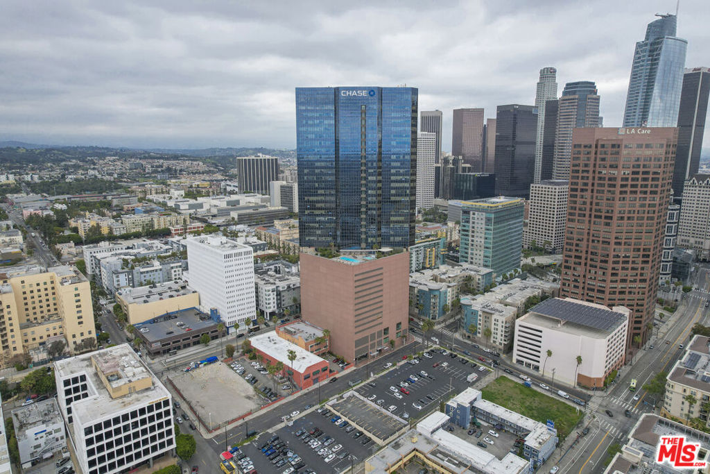 Perched on one of the highest floors at 1100 Wilshire, this striking residence offers an unmatched blend of style, comfort, and panoramic city views. From sunrise over the Hollywood Hills to dazzling nighttime skylines framing Downtown, Dodger Stadium, and beyond, every window presents a living work of art. Inside, an airy open-concept design flows seamlessly from the spacious living room into a sleek, modern kitchen perfect for both relaxed evenings and vibrant entertaining. Recently upgraded with gleaming marble countertops, a brand-new Bosch dishwasher, and stainless steel appliances, the kitchen pairs contemporary elegance with everyday functionality. The primary suite is a private urban retreat, featuring sweeping city views, a custom walk-in closet, and an updated spa-like bathroom with white quartz countertops. A lofted flex space provides the ideal setting for a second bedroom, guest area, or inspiring home office, while a full second bathroom and dedicated laundry room near the entry add convenience and versatility. As a resident of 1100 Wilshire, you'll enjoy world-class amenities designed for resort-style living, including a dramatic 17th-floor sky deck with a heated infinity pool, elevated spa, private cabanas, and lounge beds overlooking the skyline. Additional luxuries include an outdoor dining terrace with BBQ stations, a fire pit lounge, pet park, cutting-edge fitness center, media and business suites, EV charging, guest parking, 24-hour attended lobby. Perfectly situated near LA Live, the Financial District, Walt Disney Concert Hall, The Broad, acclaimed dining, luxury shopping, and the new Metro line to the beach, this residence offers a lifestyle defined by sophistication, convenience, and unforgettable views. It comes with 2 rare reserved parking spots on a coveted area of the garage close to the entrance. Electricity, gas, water, and trash are all included in the rent. Prospective tenants may rent the home either furnished or unfurnished (to be discussed upon request).