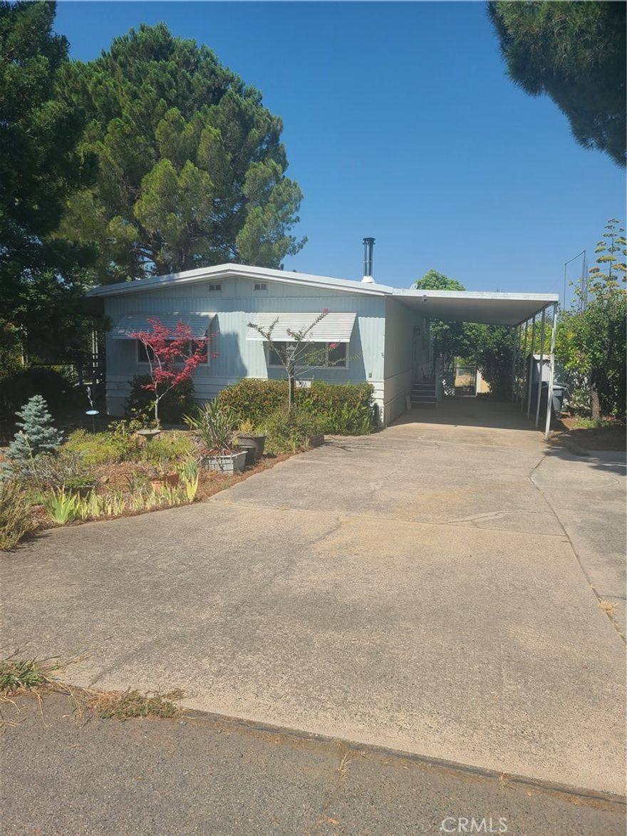 Here's a home to get started !!! Quiet area, backyard is the old Kelly Ridge golf course. Landscaped with rock, fruit trees lots of shade.  Peach tree, Orange tree, Lemon tree multiple plants all on auto drip system.  Did I say lots of shade.  Large carport, plenty of parking.  Fit your RV or boat. Easy access to main road.  Interior has also been upgraded, new paint, carpet, ceiling fans, very clean.  Come take a look inside!! More photos to follow.