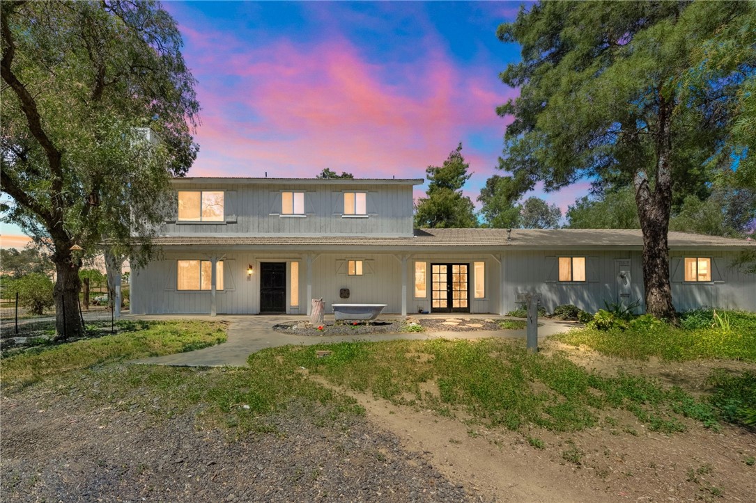Welcome to your peaceful ranch retreat on 5 picturesque acres just moments from Temecula's acclaimed wine country! This beautiful property features horse stalls and plenty of open space, which is ideal for equestrian enthusiasts. Enjoy sunny days lounging by your sparkling pool or exploring your expansive grounds. Inside, discover a versatile floorplan with a fantastic opportunity for an in-law suite—simply add a shower or tub to complete and then have a 1-bedroom converted apartment downstairs off the pool. The lower level has stained concrete flooring for easy cleaning while the upstairs has new vinyl flooring with 3 beds and 2 bathrooms. The primary suite boasts amazing natural light and a huge deck. Outside you have a full usable 5 acres equipped with a giant detached 4+ car workshop/garage (36’x 28’ with a 12’ x 28’ w/ attached lean to), horse facilities (3 stall barn, chicken coop & so much more! The opportunities are endless here on Bootlegg. Zoned for highly desirable Temecula schools, this home perfectly combines rural tranquility with convenient access to shopping, dining, and award-winning wineries.