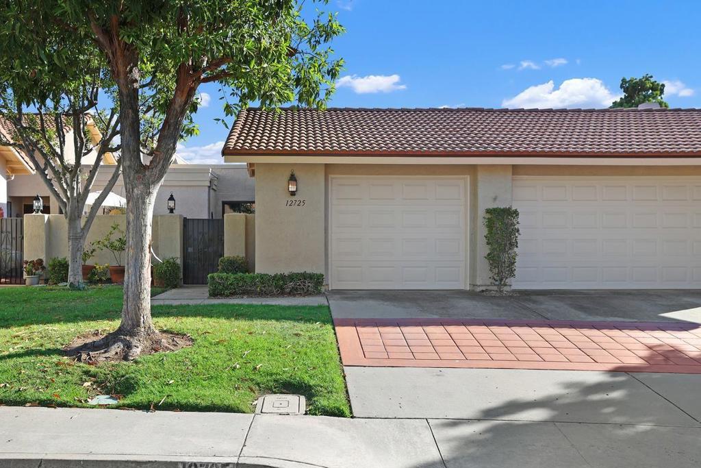 This charming, cozy single-story home at the top of Oaks North Villas offers sweeping panoramic views and no direct rear neighbor. It features a gated courtyard, vaulted ceilings, skylights, and fresh interior paint, creating a bright and airy ambiance. The remodeled kitchen is perfect for entertaining, with granite countertops and seating, beautiful cherry wood cabinets with pull-out drawers, and stainless steel appliances. The home includes dual bedroom suites for maximum comfort and privacy. One suite has a walk-in closet and soaking tub, while the second offers a large walk-in tiled glass enclosed shower, mirrored closet doors, and direct access to the rear patio for enjoying the breathtaking views. Additional highlights include vinyl plank and tile flooring, an interior laundry room with upper cabinetry, sink, and countertop. There is direct access to the garage, which has built-in closet/cabinetry for extra storage. The private rear patio is ideal for unwinding and enjoying the views! Residents of Oaks North, a 55+ community, enjoy amenities such as a clubhouse, heated pool and spa, pickleball, and tennis courts. The home is located just minutes from the Bernardo Winery and the Oaks North Community Center.