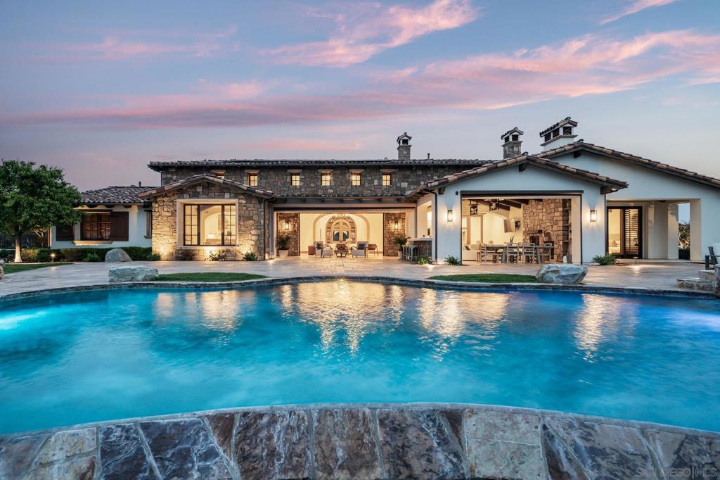 Welcome to 8415 Run of the Knolls, a true architectural masterpiece located in the, guard-gated golf enclave of Santaluz. A statement of modern luxury, this exceptional San Diego coastal estate captivates with breathtaking, panoramic ocean views, seamlessly blending refined elegance with the tranquility of its natural surroundings. Perched high above the 18th Green and Clubhouse, this ultra-private, 1+ acre estate offers an unparalleled blend of sophistication, serenity, and exclusivity. Designed for the most discerning clientele, this expansive single-level residence spans approximately 6,872 square feet, featuring five en-suite bedrooms and 5.5 bathrooms—each meticulously crafted to provide the utmost in comfort and privacy. Every facet of this extraordinary estate evokes 5-star resort-style indulgence, from its masterfully executed designer finishes to its state-of-the-art smart home technology. Whether entertaining or unwinding in solitude, this exceptional property delivers an uncompromising lifestyle in one of Southern California’s most coveted private communities. Major Mello Roos bonds have been Paid in Full.