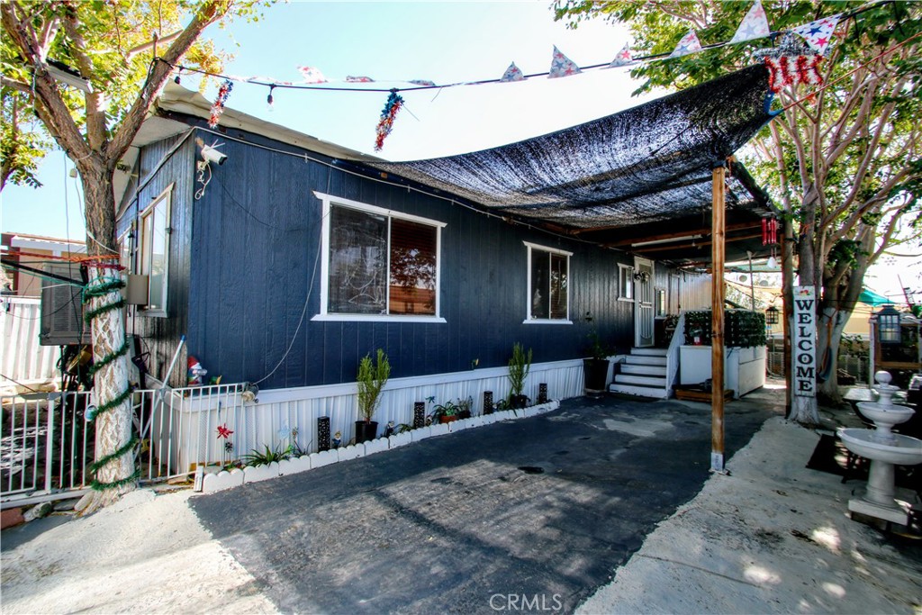 Welcome to Joshua Mobile Estates. This 2-bedroom, 2-bath manufactured home offers comfort, privacy, and convenience right in the heart of Joshua Tree. Step inside to an open layout with updated bathrooms, new laminate flooring, and a remodeled kitchen with Formica counters, refrigerator, dishwasher, and 6-burner stove included. Central air and heat keep the home comfortable year-round, and the separate laundry room comes with washer and dryer. The property is fully enclosed by a 6 foot privacy fence, giving you a private outdoor space to relax or entertain while enjoying desert and mountain views. Just steps from the community pool and walking distance to downtown Joshua Tree Village, the JT Saloon, shops, and restaurants, with the National Park only minutes away. With affordable space rent and move-in ready updates, this home is a great fit for anyone ready to make Joshua Tree their home.
