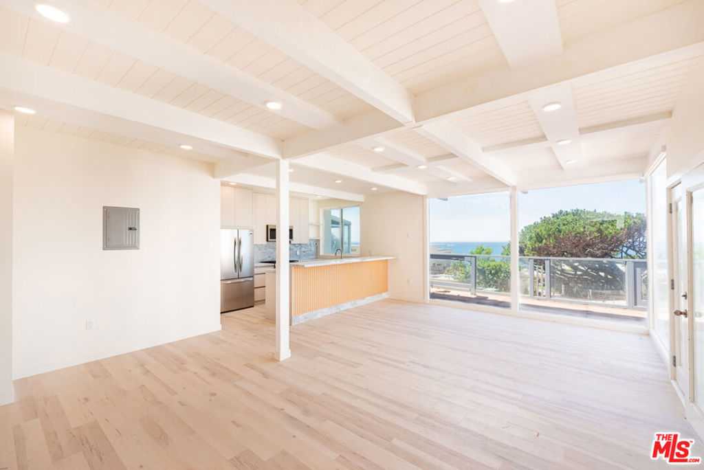 Situated in the coveted Point Dume neighborhood of Malibu, this beautifully appointed 2-bedroom, 2-bathroom unit offers a serene coastal retreat with both bedrooms featuring ensuite baths for ultimate privacy and comfort. The spacious primary suite boasts stunning ocean views, abundant natural light, and a spa-like bathroom with skylights that flood the space with warmth and brightness. The second ensuite bedroom is perfect for guests, a home office, or a peaceful retreat of its own. Enjoy seamless indoor-outdoor living with large windows, open-concept common areas, and tasteful finishes throughout. Just minutes from the sand, this home provides easy access to Point Dume State Beach and the area's scenic trails and surf spots. A rare opportunity to live in one of Malibu's most prestigious and picturesque communities.