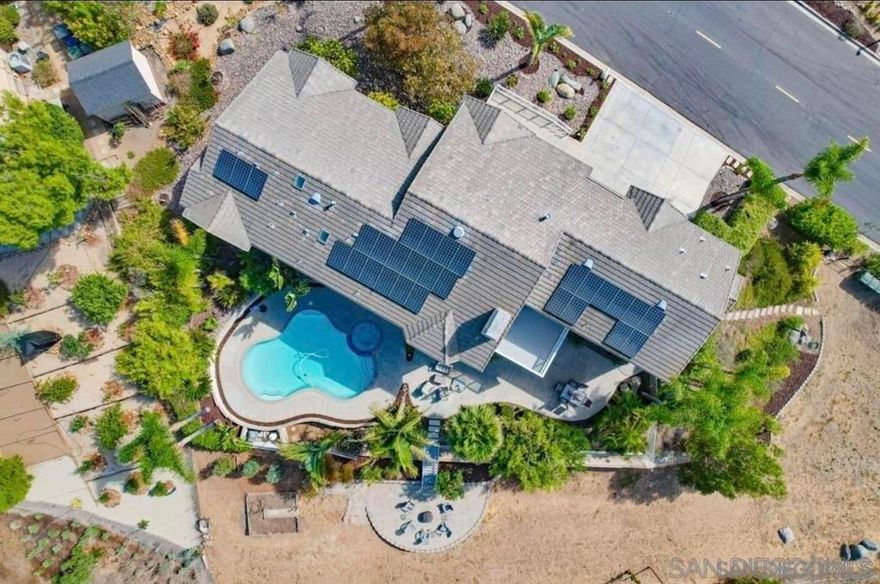 Experience elevated living in this exceptional 4 bedroom,4 bath +office, 3,620 sq. ft. home, ideally situated on a rare 0.49-acre corner lot in one of the area’s most desirable neighborhoods—with NO HOA or Mello-Roos. This stunning residence offers breathtaking views, refined design, and an open, thoughtful floor plan ideal for both everyday comfort and entertaining. The spacious layout includes a 3-car garage and a permitted 650 sq. ft. bonus room, currently used as a game room (not included in the total square footage). Enjoy the best of indoor-outdoor living with a private POOL and spa, along with OWNED SOLAR for energy efficiency. A completely separate guest space offers flexibility for multigenerational living, a home office, or rental potential—featuring its own entrance. Land with separate access with a potential for adding ADU and much more. Located within the award-winning Poway Unified School District, this home combines space, privacy, and location into a rare opportunity.  Installed built in cabinets and 3 workstations in office 2014 • Owned Solar system and installed with 29 - 305W LG panels with Enphase microinverters in 2015 • Installed raised patio on lower back yard in 2015 • 650 sq foot permitted storage room finished on 1st floor in 2016 • Pentair variable speed pool pump installed in 2017 • Replaced 50-gallon water heater and inline pump 2019 • Pool plaster refinished and tile replaced in 2021 • GE microwave replaced in 2024 • Refinished kitchen and bathroom cabinets in 2024 • Walls, doors, trim painted in 2024