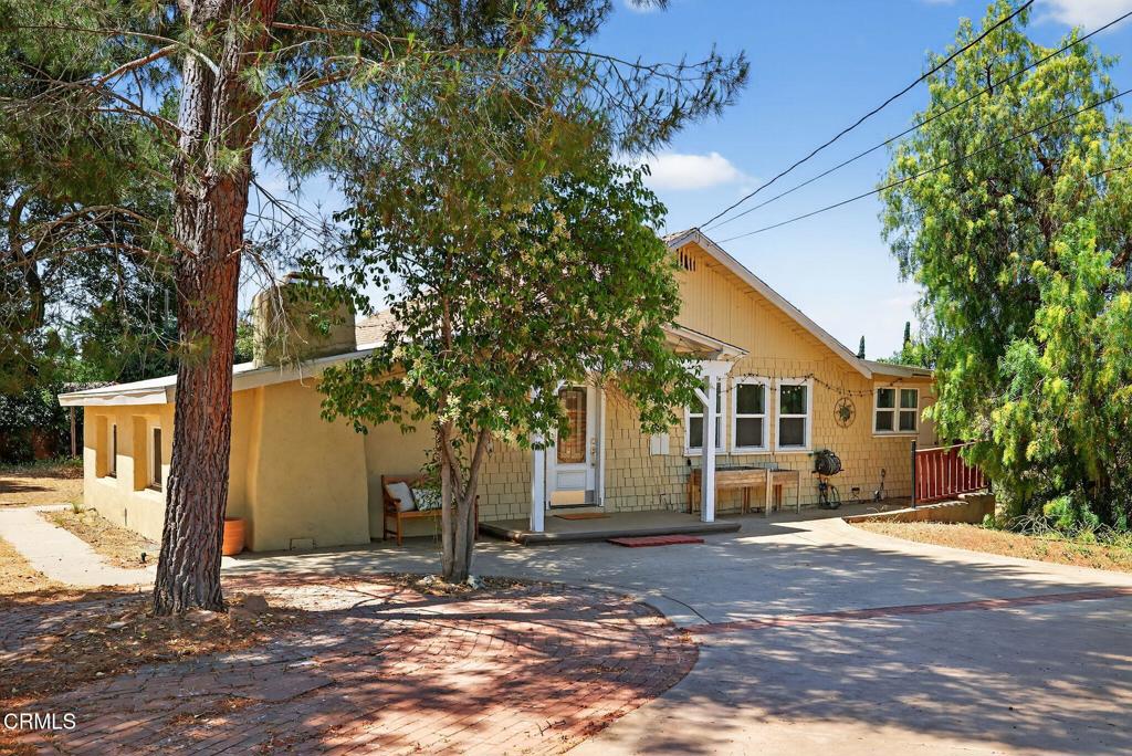 Welcome to Your Private Ojai Oasis...Two Beautiful Single-Story Homes on 1.29 Acres! Discover the perfect blend of comfort, charm, and versatility with this rare Ojai property featuring two separate single-story homes and a large multi-purpose workshop/storage building, all set behind a secure electric gate on a spacious and beautifully maintained 1.29-acre lot. The main house offers 3 spacious bedrooms and 2 full bathrooms across a thoughtfully designed floor plan. Step into the inviting living room with a cozy wood-burning fireplace, perfect for relaxing evenings. The gourmet kitchen boasts white shaker cabinets, stainless steel appliances, granite countertops, and a decorative tile backsplash. The expansive primary suite includes a private sitting area, remodeled bathroom with granite countertops, and barn-style closet doors for added character. Engineered bamboo flooring, stone tile, and a dedicated laundry room (washer & dryer included) complete the main residence. The guest house is equally impressive with 2 bedrooms, 2 full bathrooms, and an open-concept living space featuring the same high-quality finishes--white shaker cabinets, stainless steel appliances, granite counters, and tile accents. Enjoy a private laundry room, a tankless water heater (less than 1 year old), and an attached 2-car garage--perfect for extended family, guests, or rental income. A large, detached building offers ideal space for a workshop, studio, storage, or additional garage use--endless possibilities for creatives, hobbyists, or small business owners. Outside, enjoy fresh eggs from your own chicken coop, ample room to garden, and space to relax under the stars. Located just minutes from Villanova School, Ojai Valley Trail, the Ojai Valley Inn, and the charming downtown Ojai with its unique shops and top-rated dining. This is a truly unique opportunity to own a versatile, move-in-ready compound in the heart of the Ojai Valley. Whether you're seeking multi-generational living, investment potential, or your own private sanctuary, this property checks all the boxes!