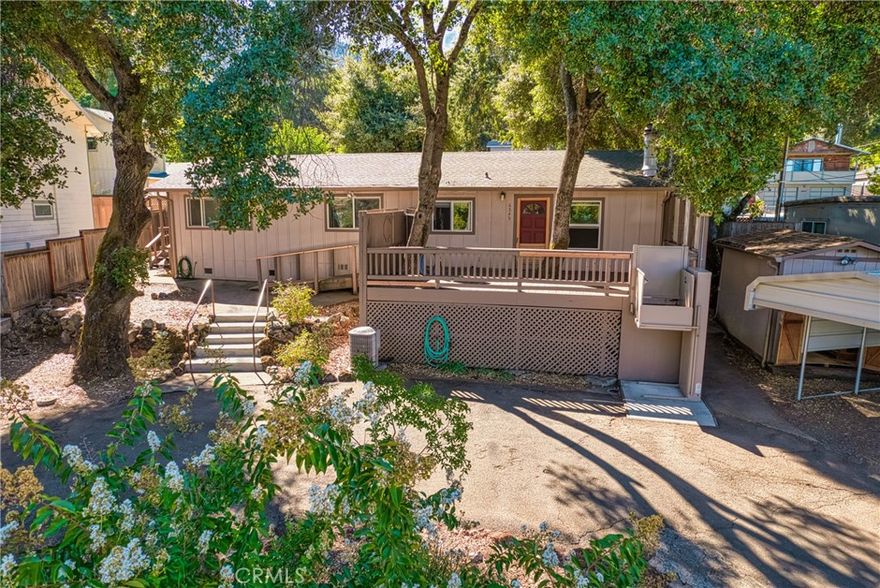 Affordable Stick Built Home - walking distance to the water! Enjoy lake views and community lake access from this low maintenance stick built home in quiet neighborhood! This 2bdrm/2bth home is the perfect spot for a summer vacation home or full time living. The low maintenance yard offers shade from mature trees, room for boat or RV parking (with easy circular driveway), covered carport, storage shed, and a large deck with lake views. A wheelchair ramp and an electric lift allow for easy access into the home or use the lift to bring heavy groceries up to the front door from the driveway. Inside the home you will find a kitchen with an abundance of storage, an open concept into the living room, a built-in gas fireplace, separate laundry room, and 2 bedrooms located to the back of the home for extra privacy. Both rooms have lake views directly from the bedroom widows. The master bedroom has an additional entrance allowing for rental or roommate possibilities. This home allows you to enjoy the peacefulness of lake living and the convivence of amenities close by.