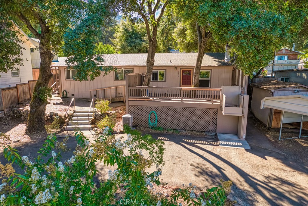 Affordable Stick Built Home - walking distance to the water! Enjoy lake views and community lake access from this low maintenance stick built home in quiet neighborhood! This 2bdrm/2bth home is the perfect spot for a summer vacation home or full time living. The low maintenance yard offers shade from mature trees, room for boat or RV parking (with easy circular driveway), covered carport, storage shed, and a large deck with lake views. A wheelchair ramp and an electric lift allow for easy access into the home or use the lift to bring heavy groceries up to the front door from the driveway. Inside the home you will find a kitchen with an abundance of storage, an open concept into the living room, a built-in gas fireplace, separate laundry room, and 2 bedrooms located to the back of the home for extra privacy. Both rooms have lake views directly from the bedroom widows. The master bedroom has an additional entrance allowing for rental or roommate possibilities. This home allows you to enjoy the peacefulness of lake living and the convivence of amenities close by.