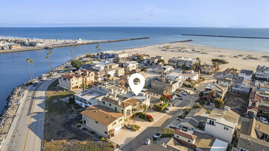 **The Ultimate Hollywood Beach Opportunity with Marina and Ocean Views**Indulge in premier coastal living from this extraordinary multi-level residence, perfectly positioned between the sands of Hollywood Beach and the vibrant Channel Islands Harbor. This is a rare offering that blends a desirable lifestyle, unparalleled versatility, and a remarkable investment opportunity in one of Oxnard's most coveted neighborhoods.The main residence welcomes you with an expansive, open-concept design where soaring tongue-and-groove ceilings and dramatic wood beams create an atmosphere of timeless coastal elegance. Bathed in natural light, warm floors flow throughout this sophisticated space, leading to a kitchen and baths ready for both quiet relaxation and lively entertaining.A standout feature that sets this home apart is the self-contained guest suite on the ground floor. With its own private entrance, kitchen, living area, and patio, it functions as a perfect sanctuary for extended family, a lavish retreat for visitors, or as a powerful income-generating asset to offset your mortgage.Ascend to your exclusive third-level deck--a breathtaking escape offering spectacular views of the marina and beach. This expansive outdoor space is your private stage for morning coffee, sunset cocktails, or unforgettable evenings spent watching the sailboats glide by under the stars.This residence represents a magnificent opportunity for the discerning buyer. Surrounded by acclaimed restaurants, yacht clubs, and the weekend farmers market, the ultimate beach lifestyle awaits. Do not miss this unique convergence of location, potential, and value. Come, explore the possibilities and capture your Hollywood Beach dream.