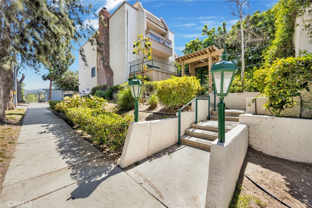 Welcome to this beautifully remodled, extra spacious tri-level townhouse located in prime Encino! Step inside this warm and inviting floor plan with high ceilings, recessed lighting, laminate flooring throughout, and plenty of room for entertaining. Kithcen is open to the family room, and features upgraded cabinets, quartz counter tops, glass mosaic back splash, and stainless steel appliances. All bathrooms have been upgraded with tile flooring, modern updated cabinets and ceramic tiled showers. Other highlights include an attached private 2 car garage, a nicely sized patio off the living room, a top floor balcony off the primary bedroom, walk in closets in both bedrooms, a spacious office area in the primary bedroom, and a top floor laundry area. Complex features a gated swimming pool area with jacuizzi, ample tree lined walkways, clubhouse/rec room, and HOA does cover earthquake insurance. Complex is also located right across the street from a park, near shopping and great schools including Encino Charter Elemantary...Too much more to mention, come see for yourselves!