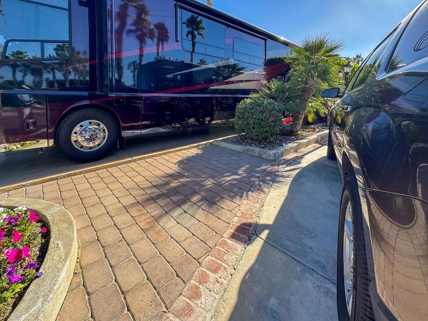 Outdoor Resort Indio is a Class A Motorcoach resort. This is an RV lot. This beautiful south-facing golf course lot that has been well-kept and offers breathtaking views of the lake, fountain, and mountains, creating a serene and private retreat with lush hedges on both sides. Ideally located on a wide street for easy backing in, this lot allows you to step directly onto the tee for a morning round or an evening stroll. Thoughtful landscaping, including a charming citrus tree and an enclosed seating area, provides the perfect setting for entertaining or relaxing under the stars with bar seating and ambient perimeter lighting enhancing the atmosphere.The well-equipped large outdoor kitchen features tiled counters with accent lighting and appliances, including a built-in BBQ, cooktop, oven, fridge, ice maker, dishwasher, and a brand-new water heater. Ample space for a car and golf cart, along with mid-lot hookups, adds convenience and functionality. This semi-furnished lot is move-in ready, offering the perfect foundation for your dream pergola and a luxurious RV lifestyle filled with comfort and unforgettable moments. Golf cart is negotiable.