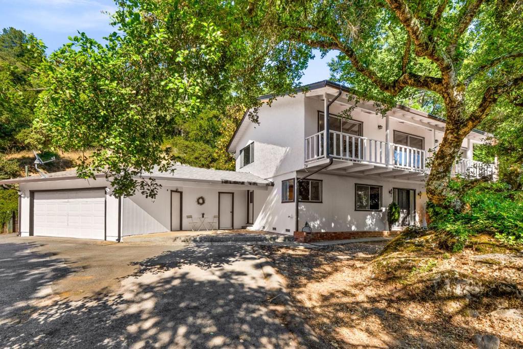 Welcome to 26025 Highland Way, a spacious 4-bedroom, 2.5-bathroom home offering 3,182 sq ft of living space in the Los Gatos Mountains. Set on a sunny open lot with panoramic views, this property provides a rare combination of privacy and accessibility. Located within the highly rated Los Gatos School District, this home offers tranquility and access to top-tier education, ideal for those in search of a peaceful mountain setting with a short drive to town. The floor plan includes a generous sized living room, kitchen, dining area, laundry room and a half bath on the ground floor with all 4 bedrooms upstairs. You'll find hardwood flooring throughout most of the home in addition to new carpet and vinyl flooring in select rooms. A long sunny deck connects 3 of the bedrooms to spectacular ocean views. This nearly 2 acre property has ample storage, including an oversized paved parking area, a finished storage room, and a two car garage. The large sunny rear yard is perfect for gardening, playing or relaxing. Take advantage of this beautiful landscape and abundant sunlight by making this serene environment your new home!