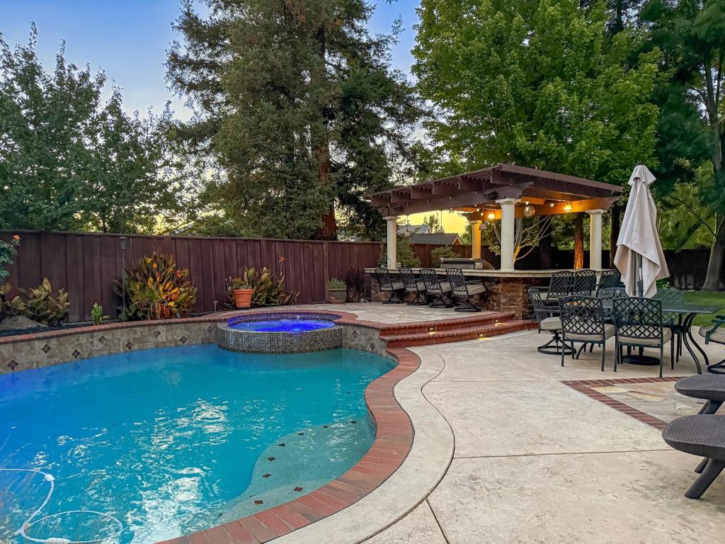The perfect family home with a backyard oasis in the highly coveted Coventry neighborhood. With over 3,100 SQFT of living space, this home's layout has room for everyone. Downstairs features high ceilings, two separate living areas, a formal dining space, plus the primary bedroom with an en suite. The kitchen has lots of counter space, a gas cooktop, a double wall oven, and an over the range microwave. The upper level has additional bedrooms plus a large bonus room that can be used for an office or media room. There are also built in speakers for those that enjoy premium audio entertainment. In the backyard you will find a solar heated pool, jetted spa, a covered full outdoor kitchen and seating area, a built-in gas fire pit, real grass, & a dog run. Smart home features include a Rachio sprinkler system and mobile app controls for the pool temperature & waterfall feature. This is the one you've been waiting for!
