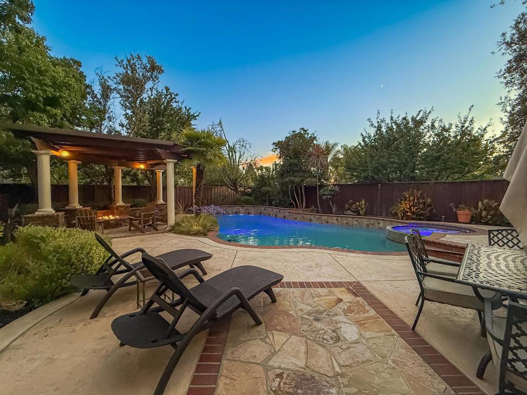 The perfect family home with a backyard oasis in the highly coveted Coventry neighborhood. With over 3,100 SQFT of living space, this home's layout has room for everyone. Downstairs features high ceilings, two separate living areas, a formal dining space, plus the primary bedroom with an en suite. The kitchen has lots of counter space, a gas cooktop, a double wall oven, and an over the range microwave. The upper level has additional bedrooms plus a large bonus room that can be used for an office or media room. There are also built in speakers for those that enjoy premium audio entertainment. In the backyard you will find a solar heated pool, jetted spa, a covered full outdoor kitchen and seating area, a built-in gas fire pit, real grass, and a dog run. Smart home features include a Rachio sprinkler system and mobile app controls for the pool temperature & waterfall feature. This is the one you've been waiting for!