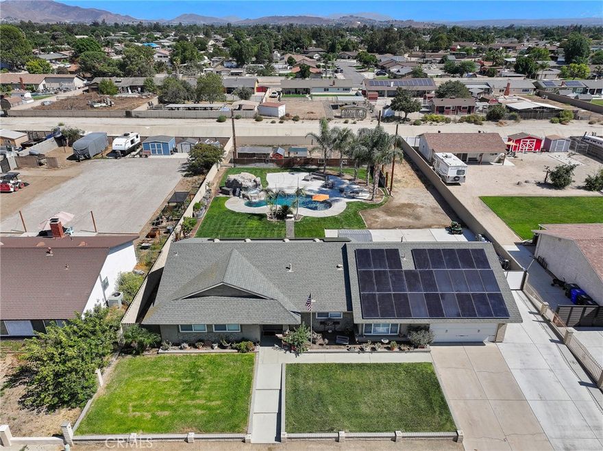 Welcome to the highly coveted neighborhood of Sky Country, where ranch living meets modern comfort and endless opportunities! This beautifully updated ranch-style home sits on a spacious flat half-acre lot offering the perfect blend of country charm and modern convenience. The focal point of the home is a bright, airy remodeled kitchen, with newer white shaker cabinets, stainless steel appliances, custom backsplash and a window overlooking the front yard. With seamless flow into the open concept living room and custom modern fireplace for those cozy nights. Enjoy 4 bedrooms with New Carpet, Custom Barn Doors throughout and updated bathrooms, this home is truly move in ready. Notable upgrades are New Solar Panels installed in 2023 (31 panels), Epoxy Garage Flooring, Extra Insulation in attic, horse fencing in the backyard- previous owner upgraded said items in 2019-2021: Newer HVAC, newer tankless water heater, newer PEX plumbing, Newer Shutters throughout, and newer pool & spa. The thoughtful upgrades and flow of this house have been carefully thought out and ready for a new buyer to enjoy. From the *like new* interior, to the spacious exterior which features Gated RV access that runs the length of the property for your toys, a luscious grassy area and comfortable seating area overlooking the waterfalls edge of the pool and spa! Privacy fence behind the pool area hides the back half of the yard where you can give your chickens or horses some space.  Whether you’re dreaming of building an ADU, adding a workshop, or simply enjoying the open space, this property delivers the flexibility and lifestyle that Sky Country is known for. *Tax rolls show 1452 sqft, per seller the 4th bedroom sqft is not reflected in this tax roll and ttoal sqft is closer to 1652. Buyer to verify*