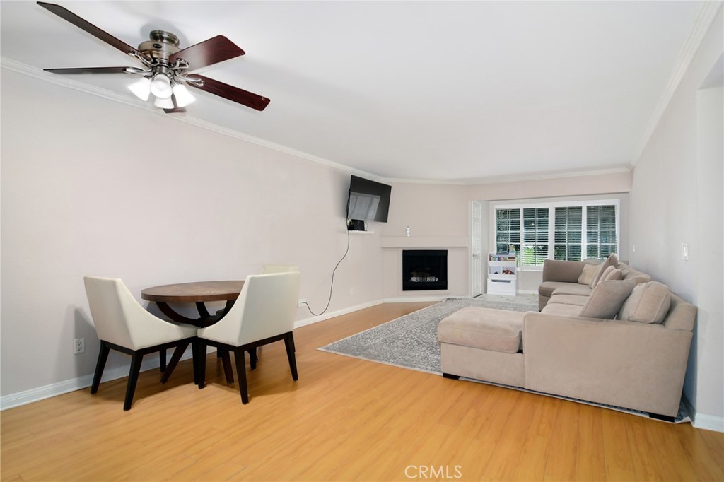 Resort style living in the heart of Warner Center, welcome to The Met! Immaculate 2 Bed + 2 Bath condo located on the 1st floor of building #3. Turn key unit tucked away at the back of the building, walking distance to the main pool, gym & tennis courts. Certainly the most desirable floor plan, this style utilizes an open concept with a guest bedroom and full bath up front, while the master sits at the back of the unit with views of the exterior! The master bedroom also offers a luxurious en suite bathroom featuring double vanity sinks in addition to an enormous closet. This spacious and beautiful condo features such amenities as wood style flooring throughout (NO CARPET), gas fireplace, granite countertops & stainless steel appliances. Designated dining room for more formal eating yet with open views to the living area and outdoor space. The living room has been extended by the original builder to allow for a larger living area, while still providing inspiring views of the rear grounds. Last but not least, your very own WASHER & DRYER IN THE UNIT + 2 COVERED parking spaces in the garage below!!! The Met is a guard gated community that offers 4 resort-style swimming pools, six night lighted tennis courts, full fitness center, racquetball, indoor basketball court, multiple spas & 24 hour guard gated security. All this located within walking distance to The Village, Warner Center Park and all the dining, shopping & entertainment Warner Center has to offer.