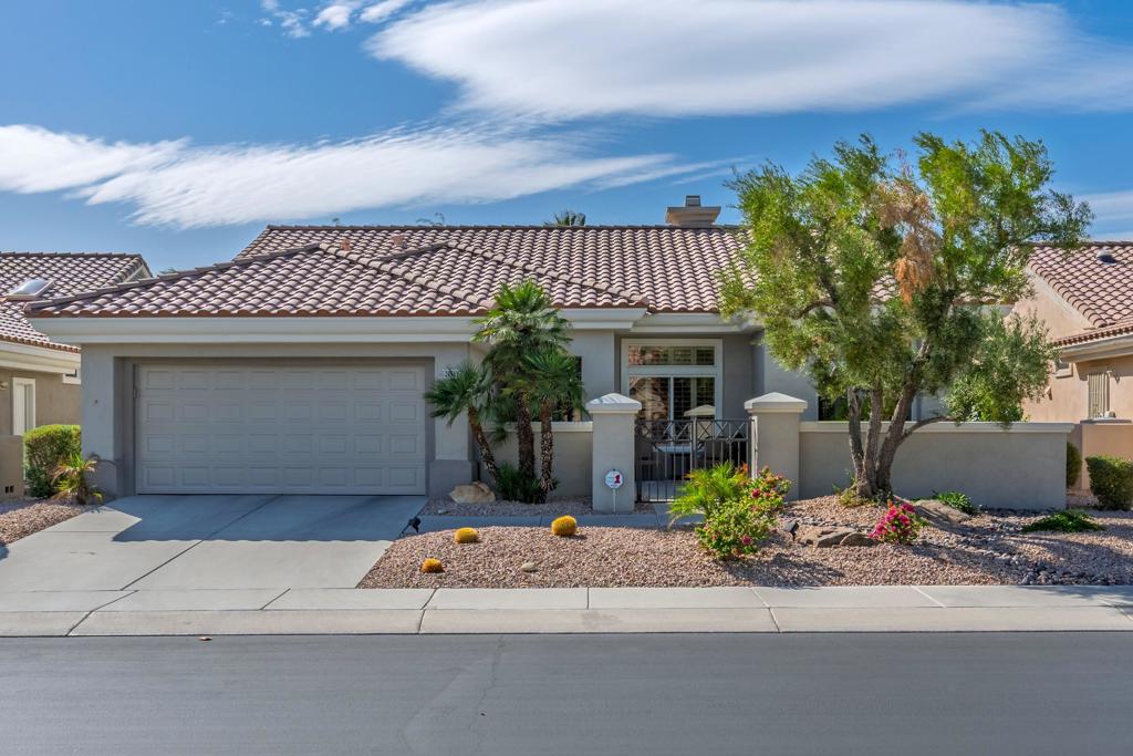 Sun City Palm Desert - Lenox. This beautifully updated Lenox model is move-in ready and exudes modern desert charm. Inside, luxury vinyl plank flooring is featured throughout, with tile in the bathrooms. Ten-foot ceilings and transom windows create a bright, open atmosphere. Upgraded lighting, fans, hardware, baseboards, and plantation shutters enhance the home's fresh, contemporary feel. The living room offers a cozy gas fireplace with a marble tile surround and a spacious media niche. The kitchen showcases quartz countertops, a subway tile backsplash, stainless steel appliances, and an upgraded sink and fixtures. Just off the living room is a versatile den or office. The primary suite features a bay window and a large walk-in closet. Its bathroom includes 12''x24'' tile flooring, a glass-enclosed stall shower, and a quartz-topped vanity with dual sinks, updated fixtures, and mirrors. The guest bathroom is similarly upgraded and includes a tub/shower combination. The laundry room provides generous storage space, and the two-car garage includes a convenient golf cart nook. Additional upgrades include a new top level air conditioner & furnace installed in 2024. Curb appeal abounds with an updated exterior paint scheme and a gated front courtyard. The rear yard offers an extended patio, alumawood patio cover, and a soothing water feature surrounded by lush desert landscaping -- the perfect setting for relaxing or entertaining
