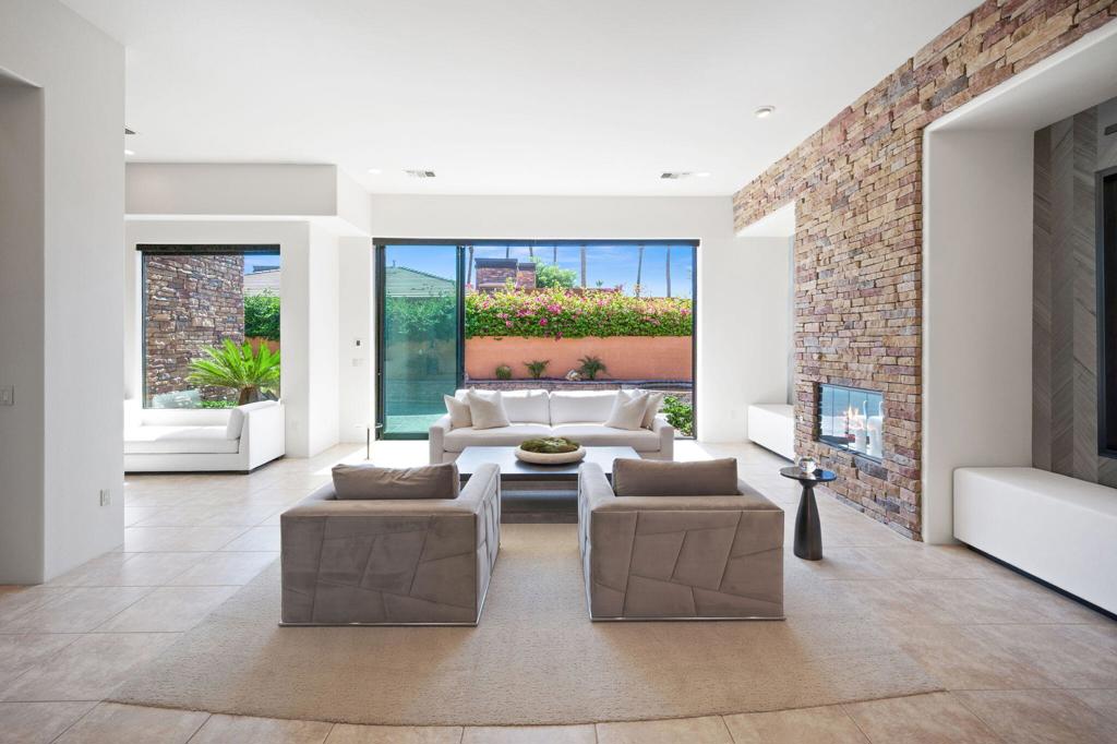 LIMITED TIME OFFER: FURNISHED + $10,000 BUYER CREDIT TO BE USED FOR CLOSING COSTS OR A BUY DOWN RATE IF UNDER CONTRACT BY 9/1/2025.Don't miss the opportunity to own this luxurious and stylish ''designer showcase'' home with a unique ''Casita in the Sky,'' located in the award-winning community of Palmilla in La Quinta.The spacious and private primary suite is built for luxury featuring an expansive wing fully private with a romantic fireplace, dual vanities, dual walk-in closets and direct access to the pool and spa for ultimate relaxation. Additional, two generously sized well appointed suites one with a private entrance offers privacy for guests as it is complete separate to the primary suite and on the situated at the opposite end of the estate. Upstairs, at the end of a private spiral staircase to the stars, you'll find one of the most unique casita's in all of Palmilla includes breathtaking and astounding panoramic Mountain View's from every angle. its own kitchenette and private balcony. A true lock and private guest suite or executive office with a special vibe that speaks for itself. Enjoy 4 grand fireplaces throughout the home in the living room, family room, and primary suite and poolside deck adding warmth and sophistication is an entertainers dream. The modern chef's kitchen boasts a 5-burner cooktop, center island, breakfast nook, bar seating, ample storage, and a walk-in pantry.Floor to ceiling roll back sliding glass doors open up like a foldaway wall leading to a large, private patio with a lagoon style pool and tanning shelf ideal for luxury living. Entertaining or pure quiet luxury living, this estate has it all. Over 4500 square feet of excellence and that's not all. A private access gate leads directly to The Citrus Club, where you can enjoy golf, fitness, and social amenities.This spacious 4,500 sq. ft. estate includes a designer furniture package. This is perfect for buyers looking for instant luxury living without the hassle of furnishing it.