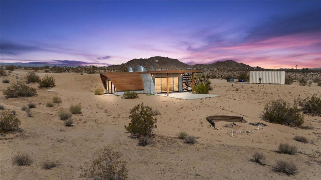 One-of-a-Kind Architectural Gem in Joshua TreeDiscover one of Joshua Tree's most extraordinary properties, a home meticulously crafted by renowned architect Fritz Haeg. This striking modern residence was designed to both inspire and captivate, offering an imaginative living experience unlike anything else in today's market.Set on an expansive 65 acres, the property provides unparalleled privacy and sweeping desert vistas in every direction. Its expansive patio is a perfect retreat for stargazing, reflection, or unwinding after a day of adventure in the high desert.The home's thoughtful details include:-Custom-designed bathroom and outdoor shower-Soaring ceilings and dramatic open spaces-Polished concrete floors-Wood-accented ceilings-Enclosed garden areaAlthough the property has recently sustained fire damage, it stands ready for the right visionary contractor to restore and reimagine it back to its full artistic potential. With its rare architectural pedigree and breathtaking natural surroundings, this residence truly embodies the unique, immersive desert experience so many seek in Joshua Tree.Old listing photos are attached, giving you a glimpse of the home in its prime--showcasing the dream it once was and the incredible potential it still holds. Ready for a new owner to bring it back to life, with the possibility of adding a pool or even another structure to maximize the estate's value. Don't miss the opportunity to make this one-of-a-kind property your own. Schedule a private showing today and be prepared to fall in love.
