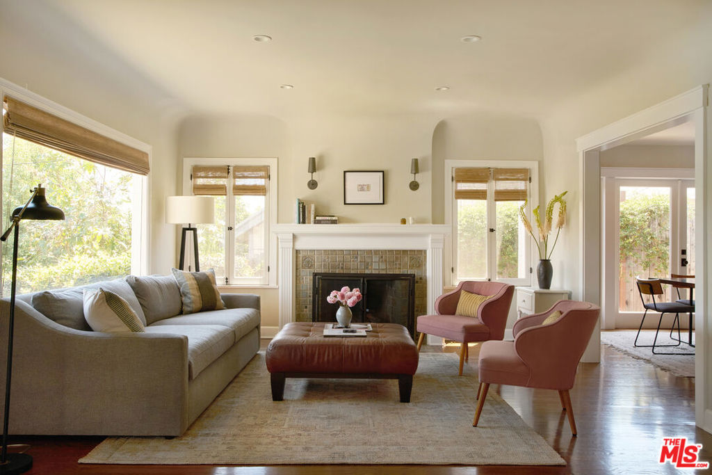 Beautifully renovated 3-bedroom, 2.5-bathroom Angelino Heights HPOZ home with an expertly landscaped backyard with pergola, hot tub, and back studio - an idyllic California retreat offering refined design, breathtaking views, and seamless indoor/outdoor living. Sitting high in the hills of this landmark historic district, surrounded by tree-lined streets, the home is a sanctuary, offering privacy and ease of living, while being close to Sunset Boulevard's best commercial offerings. Inside, original architectural elements - including coved ceilings, hardwood floors, and a striking Batchelder tile fireplace - lend warmth and integrity, while thoughtful renovations elevate the home to a new standard. The living room is wrapped in expansive windows offering unobstructed views of Echo Park's iconic hillside neighborhoods. A formal dining room opens through French doors to a sunlit breakfast patio, effortlessly connecting your living spaces. A den, currently envisioned as a music alcove and library, offers stately custom wood cabinetry and curated lighting. The marble-clad kitchen and adjoining pantry are both stylish and functional, anchored by a farmhouse sink and timeless finishes, with doors leading to the impeccable yard. Two of the home's bedrooms feature en-suite bathrooms, while a charming third bedroom with floor-to-ceiling bespoke cabinetry is conveniently located near the charming powder room. Outside, find a tiered backyard, which has been meticulously reimagined with new retaining walls and lighting scapes, maximizing every inch of outdoor space. Multiple levels offer distinct vignettes: a children's play area, dog run, a fully covered outdoor kitchen and dining pavilion, as well as a fire pit lounge and spa terrace - an entertainer's dreamscape. At the rear of the property, find a detached two-room bonus space - perfect for a creative studio, gym, or fully outfitted work-from-home suite. Located moments from Silver Lake, Elysian Park, and Downtown LA, and just minutes from neighborhood favorites like Donna's, Bar Flores, and Little Fish, this is Echo Park living at its most artful and elevated.