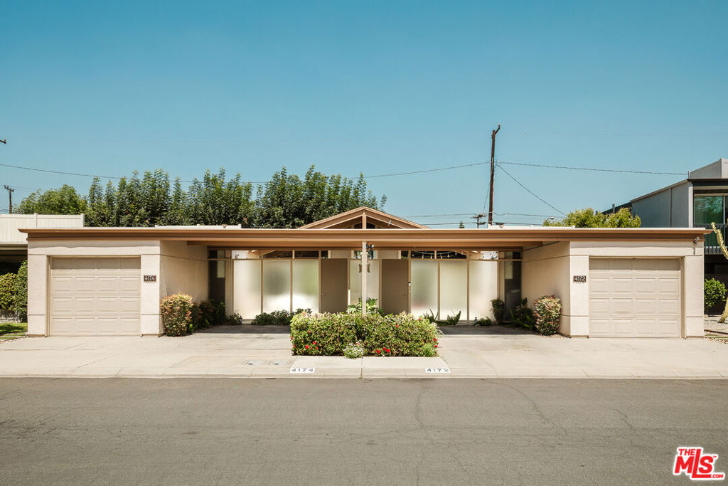 On acreage that had previously been home to pasture and training facilities for his family's thoroughbred racehorses, architect Clifton Jones Jr. developed a tract of distinguished garden home duplexes. Named Cerritos Circle, its modernist post and beam designs display the influences of his studies at the USC School of Architecture. The single story, "Plan A" model features a steeply pitched roof at its center, which shelters expansive open plan layouts under lofty beamed ceilings. The side by side 2 BD / 2 BA homes live more like custom single family residences than attached units. A central block wall divides them, with floor to ceiling sliding doors and glass walls that face entry courtyards in the front and separate fenced patio/garden areas at the back. These private patios expand the living spaces outward dramatically. Its east facing courtyard and family room are bathed in morning light, with the west facing living/dining area and back patio sunlit in the afternoon. An updated plan kitchen workspace is at each home's center, with adjacent stackable laundry. Bedrooms feature spacious closets and each has its own en-suite bath. Both units include a carport as well as a private direct access garage with a laundry area. Well situated in Long Beach's desirable Los Cerritos neighborhood- known for its tree lined streets, historic homes, excellent school district, adjacent Dominguez Gap Wetlands, and an incredibly quiet, peaceful atmosphere. A vast array of options for shopping, restaurants, and breweries are all in close proximity. Centrally located with easy freeway access for commutes to both Los Angeles and Orange County, and less than 1.5 miles from a metro station.