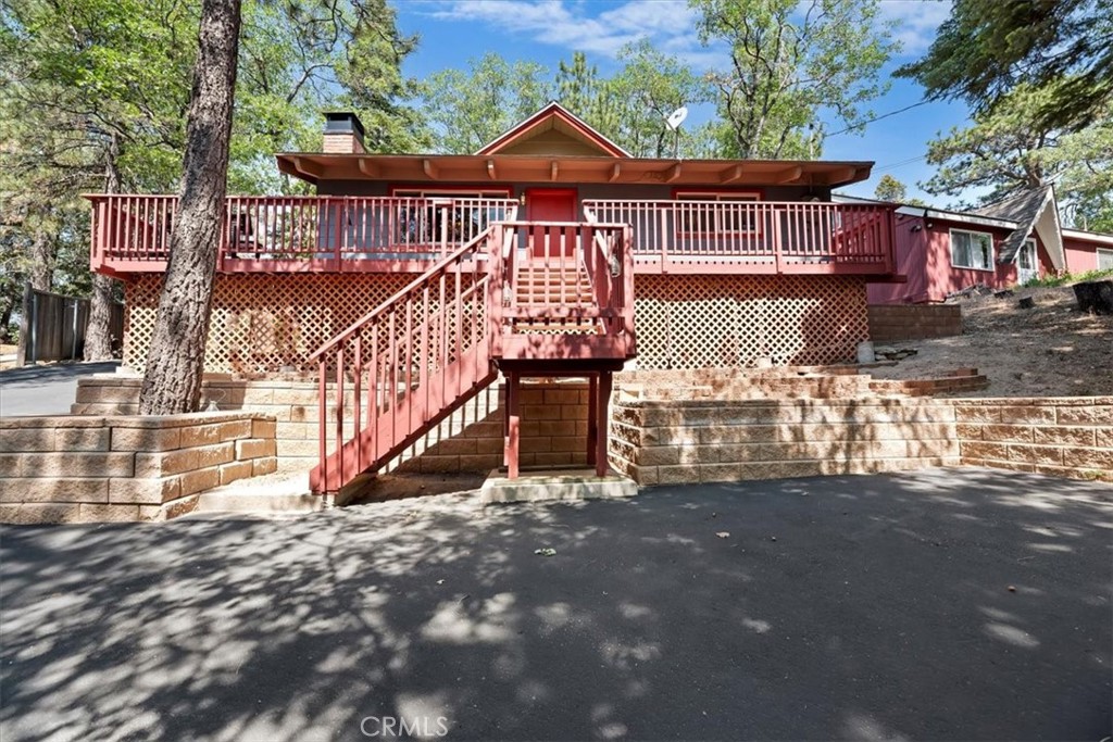Discover this Beautiful two-bedroom, one bathroom Mid-Century Mountain Cabin that is tucked away on a peaceful cul-de-sac street in the heart of Green Valley Lake. This mountain cabin offers 864 SQ. FT. of living space that sits on a generous 14,880 SQ. FT. lot that can be your ideal mountain retreat. Step inside to an Open-concept layout that seamlessly connects the living room, kitchen with a breakfast bar and eating area large brick fireplace creating a warm and inviting space that is perfect for enjoying your mornings or evenings. Notable features are: T & G Pine Ceilings, remodeled kitchen with hardwood cabinets, large brick fireplace with a raised hearth, forged steel with hand-blown glass chandelier and matching pendant lighting, Upgraded electrical, plumbing, central heating, water heater newer windows, flooring, asphalt driveway and a expansive wrap-around deck that is perfect for entertaining family or friends, sunset views, enjoying your morning coffee or evening beverage or simply curling up with a good book. This cabin is surrounded by majestic trees with a Peek view of the Old Ski Hill. This cabin has a nice back yard with a storage shed, laundry hook-ups and plenty of parking. Green Valley Lake is a year round resort town where you can enjoy fishing, hiking, swimming, mountain biking and close to the ski resorts of Snow Valley and Big Bear, there is something for everyon