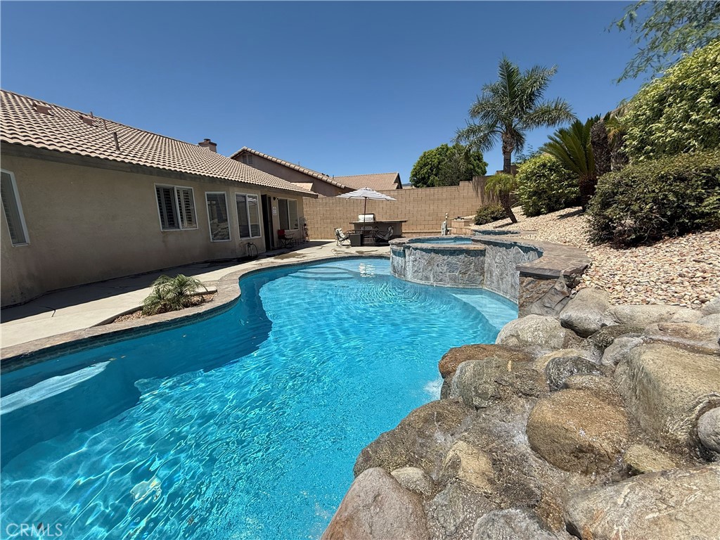 Breathtaking Fontana waterfall pool home has 4-Bedrooms, 2-Full Baths with a covered front porch and custom window shutters. Nice open and spacious floor plan with wood floors, recently remodeled kitchen, newer paint, vaulted ceilings along with recessed lighting. Large master suite with a walk-in closet, inground pool, spa with waterfall, 3-car garage, newer central heat and air unit, and much more! The property has lower taxes, solar, and NO HOA! Close proximity to shopping, schools, the 210 & 15 freeways. Don't miss this opportunity, the best part is home is sold fully furnished!