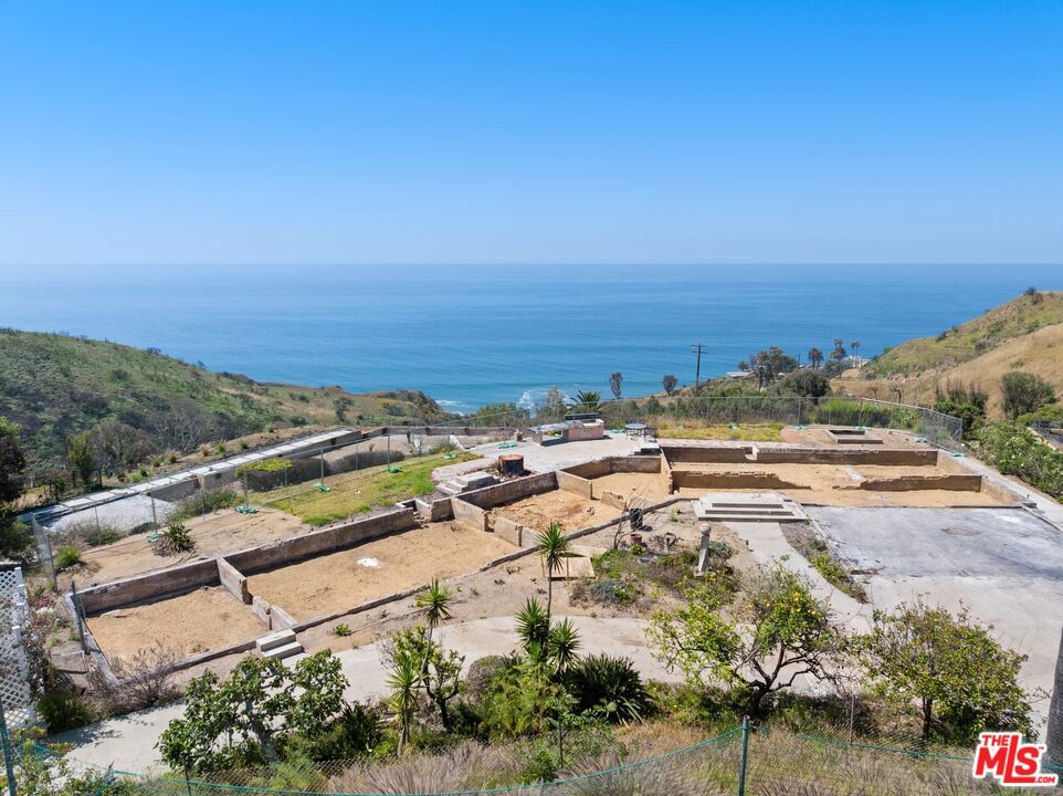 Perched in Malibu's coveted Las Flores Mesa neighborhood, this exceptional 17,246 square-foot vacant lot offers breathtaking, panoramic views of the Santa Monica Bay and the iconic Queen's Necklace. Previously home to a 4-bedroom, 3.5-bath, 3,228-square-foot residence, this flat parcel is located in one of Malibu's most private and serene enclaves. Set on a wide private road, the location offers ultimate tranquility while still being just minutes from PCH- close to world-famous beaches, Nobu, Soho House, and with easy access to the Westside. A truly special opportunity in a spectacular coastal setting.
