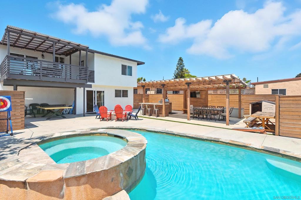 Fully remodeled, move-in-ready beach bungalow with a back yard designed for the ultimate in entertaining! Upstairs features open floor plan with living room, kitchen & dining area, as well as a large lanai overlooking the back yard. Sparkling pool with slide, bubbling spa, covered BBQ pavilion, large patio with firepit as well as a covered patio all reside out back for your enjoyment. Here is your opportunity to live the beach lifestyle and be close to shopping, restaurants, schools, Buccaneer Park and the Oceanside Pier. 2 bedrooms and 2 full bathrooms on the main level and 2 more spacious bedrooms and another full bathroom on the lower level with a sitting room and a recreation room with that leads out to your amazing back yard. See supplement for more details. Located about a half mile to the Pacific Ocean, is this tastefully remodeled mid century beach bungalow. Fully fenced front yard with two play structures over grass leads to the entry of this 4+ bedroom, 3 bath house. Enter the front door and you’ll be greeted by a spacious living room that is open to a beautifully remodeled kitchen with quartz countertops, white shaker cabinets and stainless-steel appliances. Dining area off the kitchen features a glass slider that leads out to a large lanai that overlooks the back yard. Main level also features primary bedroom with the remodeled bathroom and a secondary bedroom with another full bathroom. Head down the stairs to the lower level of this entertainer’s delight and you’ll see a sitting area that leads to a spacious recreation room that features two stacked washer/dryer combos and a separate closet. This room could also serve as a fifth bedroom should you choose. Two more bedrooms and a full bathroom are also located on this lover level that leads out to the incredible, fully-fenced back yard. A large concrete patio with firepit is connected to a covered BBQ pavilion with granite covered bar and a large dining area. Rounding out the back yard paradise is a newly-built pool with spa as well as a covered patio. Two off street parking spaces are conveniently located beyond the fence off of the rear alley. Side yard leads to front and second side yard is also fenced in.