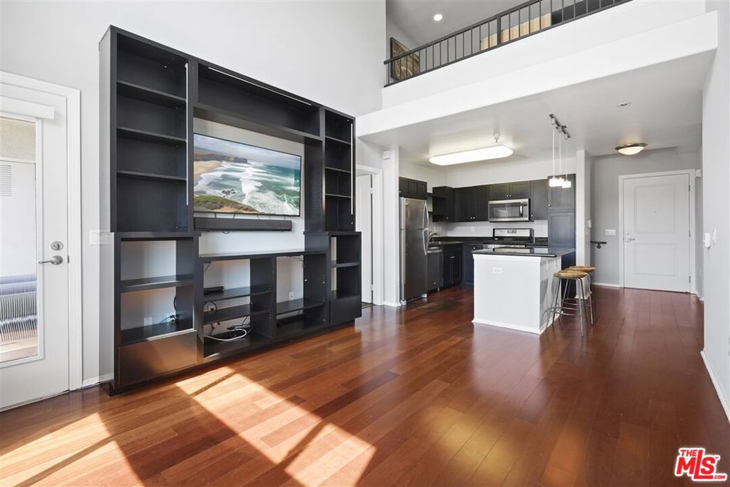 Top floor penthouse condo offering at the Savoy in Little Tokyo/Arts District. Quiet, and bright 2b/2b + Loft with 1186 sqft of living space + private balcony with sweeping views of the city and Downtown Skyline. Enjoy sun kissed afternoon sunsets in this rare penthouse offering.Unit 404 features custom entertainment center and office/storage in the upstairs loft. 2 master bedrooms with en-suite bathrooms and generous closet/storage space. Spacious living room, with 17 ft dramatic ceiling height, contemporary kitchen with stainless steel appliances. Laundry closet/storage with Washer/Dryer included. 2 Assigned tandem parking spaces (#144/145). Building includes 24 hours security and resort style amenities including oversized swimming pool, hot tub, fitness center, media room, conference room, business center, and clubhouse. A walker's paradise with a walking score of 95 and conveniently located moments away from Little Tokyo shops, Arts District entertainment, restaurants, bars, grocery store, Metro and a mile away from Union Station. Parking, water and trash are covered. Residents pay their own electricity, gas, & TV/Internet