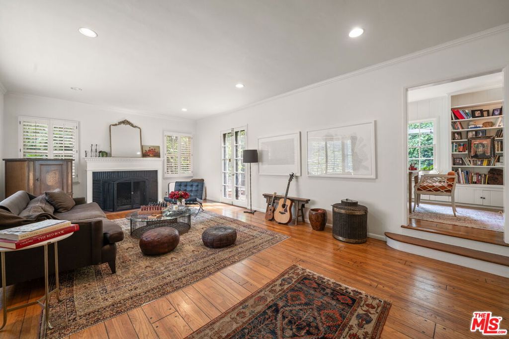 This fully furnished 4BR/4BA Traditional in The Oaks offers 2,440 sq. ft. of timeless charm with sweeping canyon and Hollywood Sign views. Set on a lush hillside lot, the home is surrounded by private outdoor spaces designed for al fresco dining and relaxed lounging. Inside, a formal foyer welcomes you into a sunlit dining room (and adjoining office), with French doors offering great indoor/outdoor flow. The step-down living room, with its natural light, decorative fireplace, and direct access to a spacious brick patio, creates the perfect setting for entertaining. A large, bright kitchen is well-equipped with all the essentials and includes a convenient stacked laundry closet. Completing the main level is a bathroom and a versatile bedroom (currently used as an office). Upstairs, the primary suite boasts an updated bathroom, ample closet space, and a skylight. Two additional bedrooms and two bathrooms, including one en-suite, provide comfort and flexibility. Additional highlights include a one-car garage and a prime location in one of Los Angeles' most coveted neighborhoods. Close to Griffith Park, Los Feliz Village, and all the Hollywood Studios. Available for a 6 to 9 month lease term.