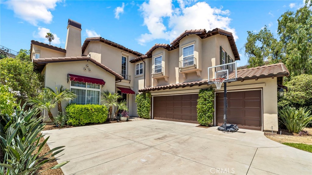 Tucked away on a tranquil cul-de-sac in the prestigious, guard-gated community of La Vina, this exceptional Mediterranean-inspired residence offers a rare blend of privacy, luxury, and peaceful community living. Nestled against the scenic backdrop of the San Gabriel Mountains, the home sits on a generous 10,441 sq ft lot and offers 3,329 sq ft of well-designed living space, creating a seamless indoor-outdoor lifestyle. Step inside to a dramatic entryway highlighted by a grand spiral staircase and soaring ceilings. The main level features formal living and dining rooms and an open-concept kitchen and family room anchored by a cozy fireplace and views of the lush backyard. The chef’s kitchen is appointed with a center island, walk-in pantry, and a sunlit breakfast area, with glass sliders leading to a serene outdoor patio - perfect for entertaining or simply unwinding under the stars. The versatile floor plan includes a convenient downstairs guest suite with private bath, while the upstairs offers a spacious primary suite with a walk-in closet and a spa-style bath, along with three additional bedrooms - one en-suite and two with a shared Jack-and-Jill bath. Additional highlights include new paint throughout, engineered hardwood floors, plantation shutters, a separate laundry room, new carpet upstairs, and a 3-car garage. La Vina is one of the few guard-gated communities in the area, offering residents 24-hour security, walking trails, and resort-style amenities including a heated pool and playground area for family fun. The tight-knit neighborhood fosters a true sense of connection, where neighbors know each other and nature is just outside your door. Homes in La Vina are rarely available - don’t miss your opportunity to enjoy tranquility, exclusivity, and timeless design in one of Altadena’s most sought-after enclaves.