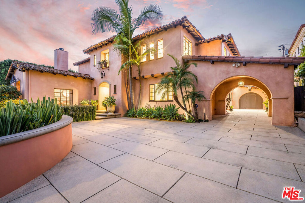 Exuding charm and exquisite detail around every corner, a rare opportunity presents itself to lease this magnificently designed Mediterranean-style estate on one of the most tranquil streets in the Beverly Hills Flats! Be enchanted by this 5-Bed / 7-Bath two-story residence spanning 4,181 sq ft on an oversized 12,000 sq ft lot. The well-manicured front yard with imported olive trees, lush greenery and Spanish-tiled fountain sets the forefront of this Mediterranean masterpiece. Step beyond the hand-carved wooden door to the foyer with parquet hardwood floors, elegant rod iron chandelier, and ceiling stenciled with Moroccan-inspired designs. Step under the cusped archways to navigate between rooms on the first level, including the living room with tall ceilings, ornate formal dining, study with wet bar, kitchen, maid's quarters, laundry room and tiled powder room. The kitchen is complete with a large island, double sinks, and top-end appliances. Ascend the stone staircase to the second level. To the left lies the primary suite with walk-in closet, fireplace, and opulent white marble bathroom complete with large tub, steam shower, double sinks and bidet. Three other en-suite guest bedrooms flank the other side of this level each with their own unique charm. Step into the backyard and be transported to a magical paradise full of lush plants and greenery. Designed to entertain with multiple seating areas. Take advantage of the outdoor Viking grill or take a dip in the refreshing pool or invigorating spa with ornate fountain backdrop. The detached guest house compliments the pool perfectly with kitchenette, half bath and motorized projector screen for movie nights. Bonus features include a basement for ample storage and convenient parking with a detached two-car garage and an abundance of parking in the elongated driveway. Located in the flats of Beverly Hills near trendy restaurants, cafes and shops in both Beverly Hills and West Hollywood. Available furnished $35,000/month.