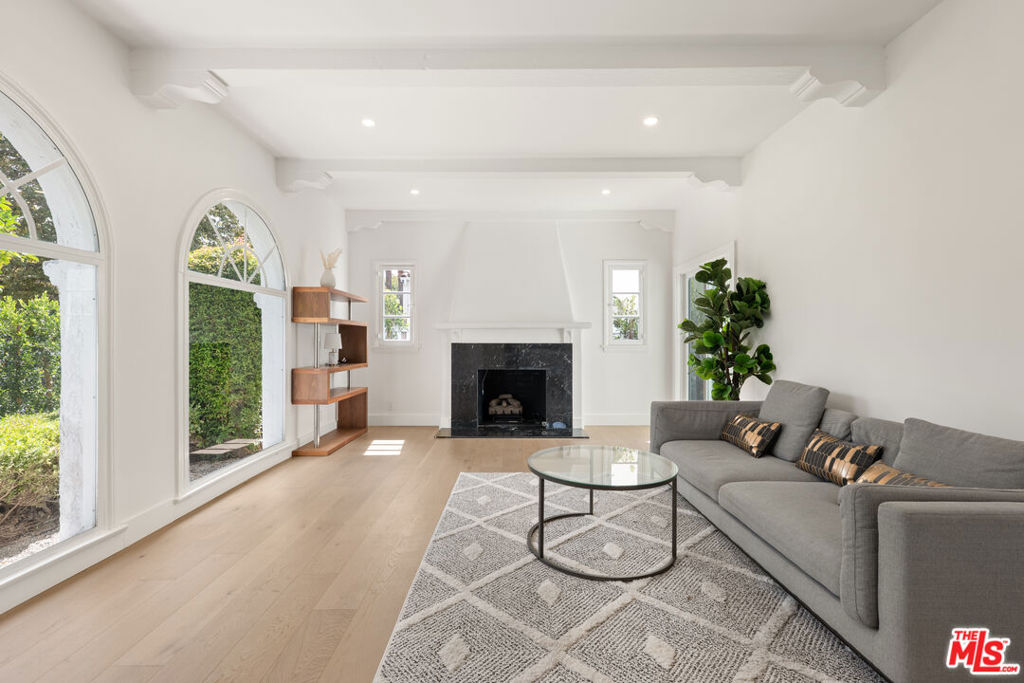 Located on one of Beverly Grove's most desirable and quiet streets, this updated first floor residence of a duplex features 3 bedrooms and 2 bathrooms with a bright, modern layout. The home includes new wide-plank oak flooring, a refreshed kitchen with quartz countertops and stainless steel appliances, and a comfortable living room with arched windows and a decorative fireplace. Both bathrooms have been renovated with modern finishes, and the bedrooms offer great natural light and closet space. Additional highlights include central heating and air, an in-unit washer and dryer, and 1 covered garage spaces. The property is offered fully furnished for a convenient move-in or can be leased unfurnished if preferred. The hedged yard provides privacy and a peaceful setting while being close to Melrose Avenue, The Grove, and West Hollywood. A great opportunity to enjoy an updated home in a prime Beverly Grove location.