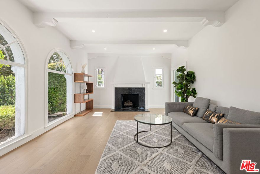 Located on one of Beverly Grove's most desirable and quiet streets, this updated first floor residence of a duplex features 3 bedrooms and 2 bathrooms with a bright, modern layout. The home includes new wide-plank oak flooring, a refreshed kitchen with quartz countertops and stainless steel appliances, and a comfortable living room with arched windows and a decorative fireplace. Both bathrooms have been renovated with modern finishes, and the bedrooms offer great natural light and closet space. Additional highlights include central heating and air, an in-unit washer and dryer, and 1 covered garage spaces. The property is offered fully furnished for a convenient move-in or can be leased unfurnished if preferred. The hedged yard provides privacy and a peaceful setting while being close to Melrose Avenue, The Grove, and West Hollywood. A great opportunity to enjoy an updated home in a prime Beverly Grove location.