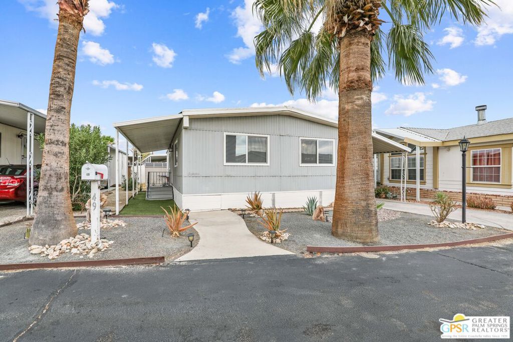 Located in the picturesque Desert Palms Community, this charming 2-bedroom, 2-bathroom home offers comfort and modern touches in a serene, gated setting. Featuring tile flooring throughout the main areas and updated laminate floors in the halls and bedrooms, this residence is both stylish and functional. The dual-pane windows have been recently replaced, enhancing energy efficiency while allowing natural light to pour in.The guest bathroom which has been tastefully remodeled, offers a fresh and inviting space. The kitchen, while it needs some updated aesthetics, includes a stainless-steel range hood and refrigerator, adding a sleek contemporary touch to the home. Inside, the living room is spacious; the bedrooms are generously sized and the primary suite includes multiple closets for optimum organization. Window blinds provide privacy while complementing functional elements. Outside, you'll find a well-maintained front yard with desert gravel and faux turf walkways, giving the space a clean and low-maintenance appeal. The carport offers ample parking along with a driveway, while a utility sheds provide extra storage solutions. This home is situated in an all-age park, making it suitable for a variety of lifestyles. It offers a pool, spa, RV parking, playground, workout room, club house, BBQ, dog park and onsite management. The area is peaceful and serene, ideal for those seeking a quiet environment with affordable space rent. Don't miss this opportunity to live the desert lifestyle in this beautiful Desert Palms Community. Park Approval required. Space rent will be $678.00, Trash: $48 and Sewer: $31.96.