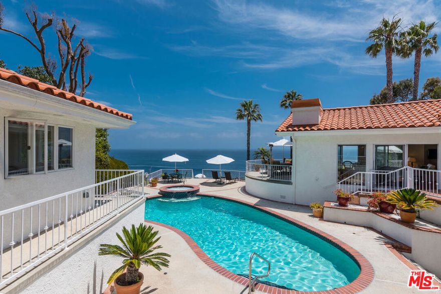 Perfectly situated for panoramic vistas, light and spacious gated Mediterranean villa on Pt Dume bluff. Open interior, expansive grounds for casual living and sophisticated entertaining. High ceilings, skylights, walls of glass, hardwood floors, multiple ocean-view patios and decks, pool/spa, lawns, trail to Big Dume Beach. Enormous living room with wood-plank ceiling, windows on three sides, stone fireplace with seating, decks outside; large family/media room/library with bookcase walls and projection screen, huge dining area, wet bar. Skylight kitchen has wood cabinets, marble countertops, hammered copper stove hood, breakfast bay seating with windows. Sensational pool-and-ocean-view master with trussed ceilings, fireplace, spa-style bath with glass-block wall. Indoor spa with massage room, Jacuzzi, cold plunge, sauna. Fountain motorcourt entry with ample guest parking, paddle tennis court, and separate guesthouse with full kitchen. This is Malibu living at its most comfortable.