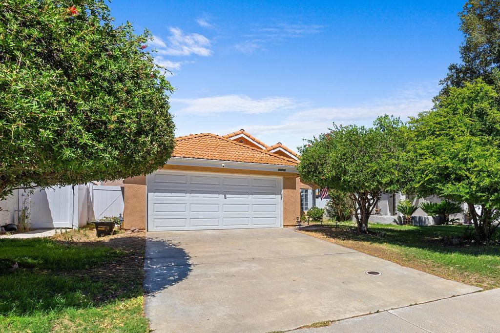 This charming single-story residence, built in 1988, offers 902 square feet of thoughtfully updated living space on a spacious 5,227 square foot lot. Featuring 2 bedrooms and 2 bathrooms, this home is ideal for comfortable living. The expansive, flat yard and large backyard create an ideal outdoor retreat with plenty of room for gardening, entertaining, or outdoor activities. Inside, the bright interior boasts double-height ceilings that enhance the open feel throughout the living areas. The cozy living room is anchored by a fireplace, providing warmth and ambiance for gatherings. Luxury vinyl plank flooring flows throughout the main living areas, combining style with durability. Both bathrooms have been updated, including a newly remodeled master bathroom featuring a rain shower for a spa-like experience. The kitchen and living spaces flow effortlessly, offering a functional layout perfect for everyday living. Additional conveniences include a garage laundry area and a two-car attached garage that provides secure parking and extra storage space. Step-free access throughout the single-level floor plan ensures ease of movement for all residents. The property is ideally located near multiple parks, dog parks, hiking and biking trails, shopping centers, dining options, hospitals, and medical centers. Easy freeway access and proximity to local schools add to the convenience of this Temecula home. Combining functional upgrades with a welcoming atmosphere, this residence is a rare find that offers both comfort and practicality.