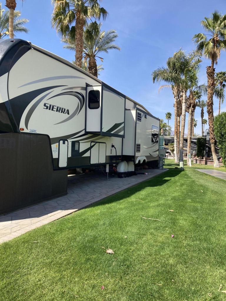 NEW LISTING LOT 1130 2016 Sierra 378FB. Situated on the back 9-hole 9 of the golf course, this lot offers stunning views of the water, fountain, and mountains. Its convenient location near the ES Clubhouse and pickle-ball courts makes it an attractive option for those seeking entertainment and recreation. The lot's right side features a greenbelt, providing a serene and private atmosphere. The property includes a gazebo with curtains and lighting, fire table, and high-end furniture. The refreshing fountain breezes enhance the appeal of this exceptional deal. The 2016 Sierra 378FB features leather sofa and recliners, bath and 1/2, en suite bathroom with double sinks, and a king-size bed.
