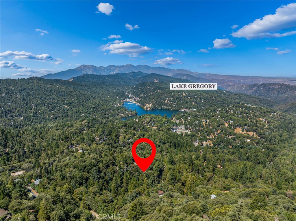 Thinking of building your own mountain getaway? Potential BIG VIEWS on this buildable, street-to-street, downsloping lot!
Once the trees are cleared, you can see Lake Gregory, Mt Baldy, all the way to Hesperia! 90' of frontage with utilities at the street or nearby. Septic area. Just over 1/3 of an acre, this location is extremely commuter-friendly and only minutes away from Lake Gregory and the Crestline shops.
This lot is priced to sell. Start building your dream home today!