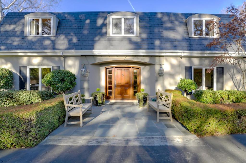 Tucked away at the end of a long, gated driveway with complete privacy. This traditional home includes parquet wood floors, crown moldings, and expansive divided pane windows that fill the home with light. The spacious kitchen includes an island breakfast bar, top-quality appliances, and built-in desks. The family room features a fireplace, wet bar, and wall of sliding glass doors to the pool and tennis court. Main level 5th bedroom, or office, and attached ensuite. Upstairs, there are 4 bedrooms, 3 with en suite bath and one served by a hallway bath. Located on approximately 1.2 acres, which includes a pool and spa, barbecue center, and tennis court. Approximately 5,525 total square feet total Main level: 2,210 square feet Upper level: 2,480 square feet 3-car garage: 715 square feet Mech room: 20 square feet Shed: 100 square feet Please see the disclosure package for in-person visit rules.