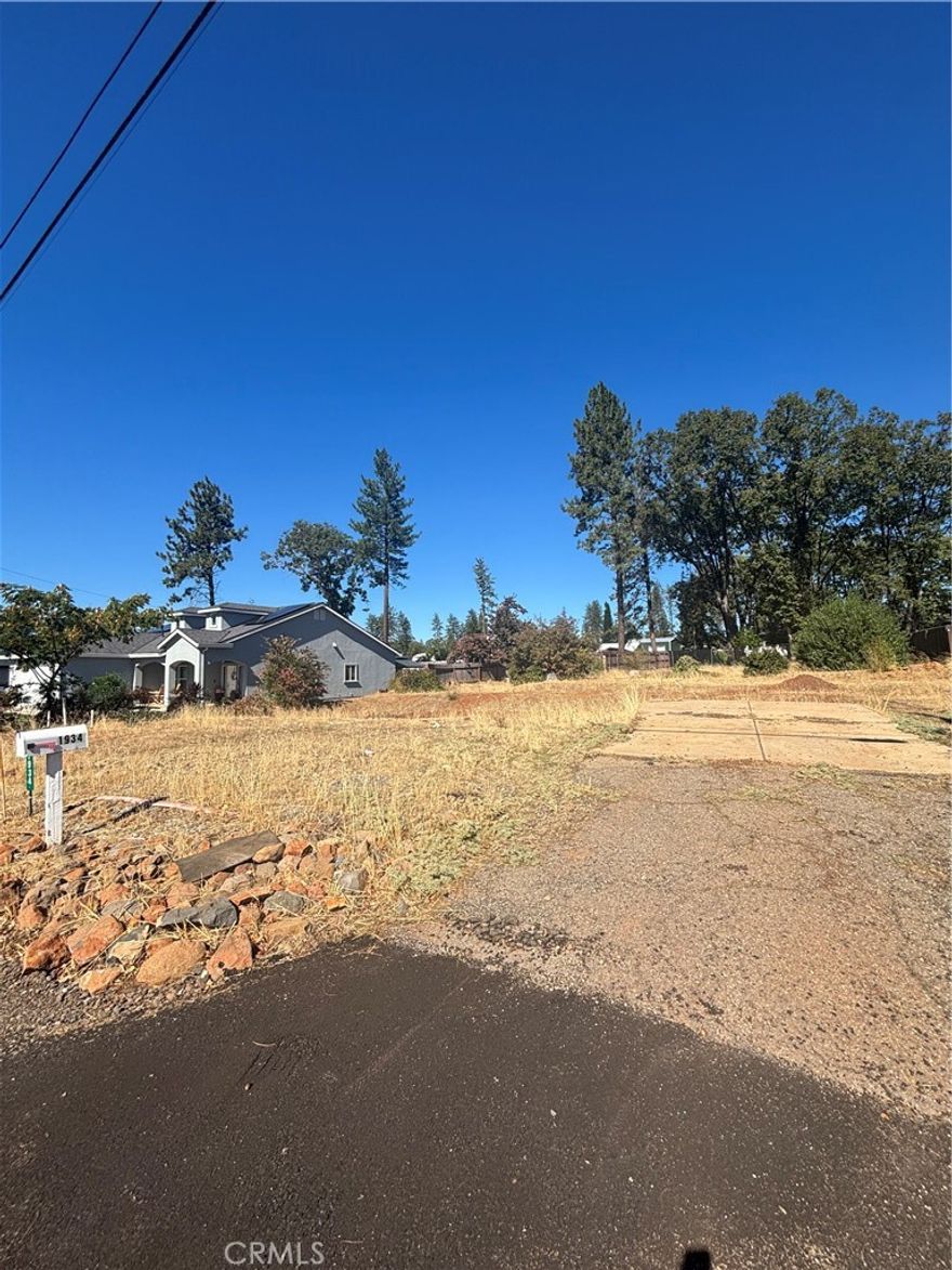 Here's a rare opportunity to own a parcel in the desirable Crandall Way neighborhood. This property comes with water service connected through Paradise Irrigation District (PID). The previous home (3 beds / 2 baths, ~1,314 sq. ft.) was lost in the Camp Fire. This cleared lot offers a clean slate for your vision — rebuild, design from the ground up, or consider modern home plans that maximize the views and terrain. With the benefit of being already platted and in a residential zone, much of the preparatory legwork is done. Conveniently situated close to local amenities, schools, and road access, this property blends tranquility with accessibility. Don’t miss your chance to restore life to a piece of Paradise’s residential fabric.