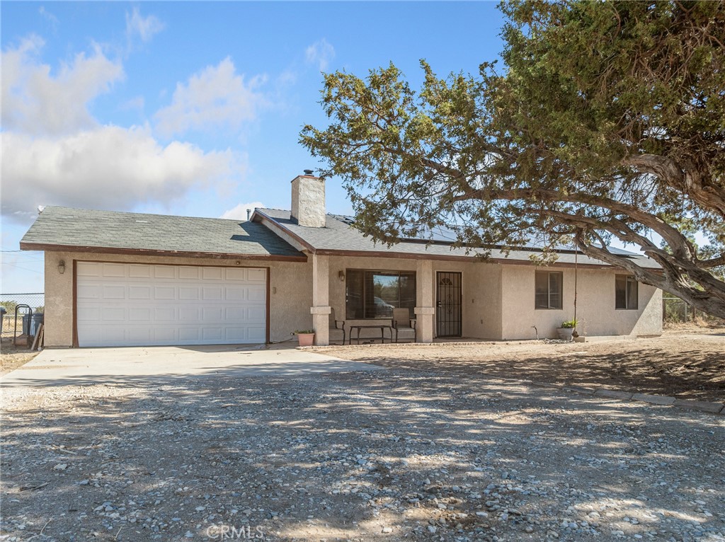Welcome to 9176 Coleridge Road in Oak Hills! This charming 3-bedroom, 2-bath home sits on a spacious 43,124 sq. ft. lot, offering endless room for RV parking, animals, toys, or future projects. Inside, you’ll love the vaulted ceilings, open floor plan, and cozy stone fireplace with wood stove. The kitchen features a large breakfast bar and ample cabinet space, while the bedrooms are well-sized, including a primary suite with a bold accent wall, ensuite bath, and direct backyard access. Energy-efficient solar panels, an attached 2-car garage, and both front and rear porches add comfort and value. Outside, the expansive lot provides plenty of potential to create your dream retreat while enjoying the quiet charm of Oak Hills. Conveniently located near schools, shopping, dining, and commuter routes.