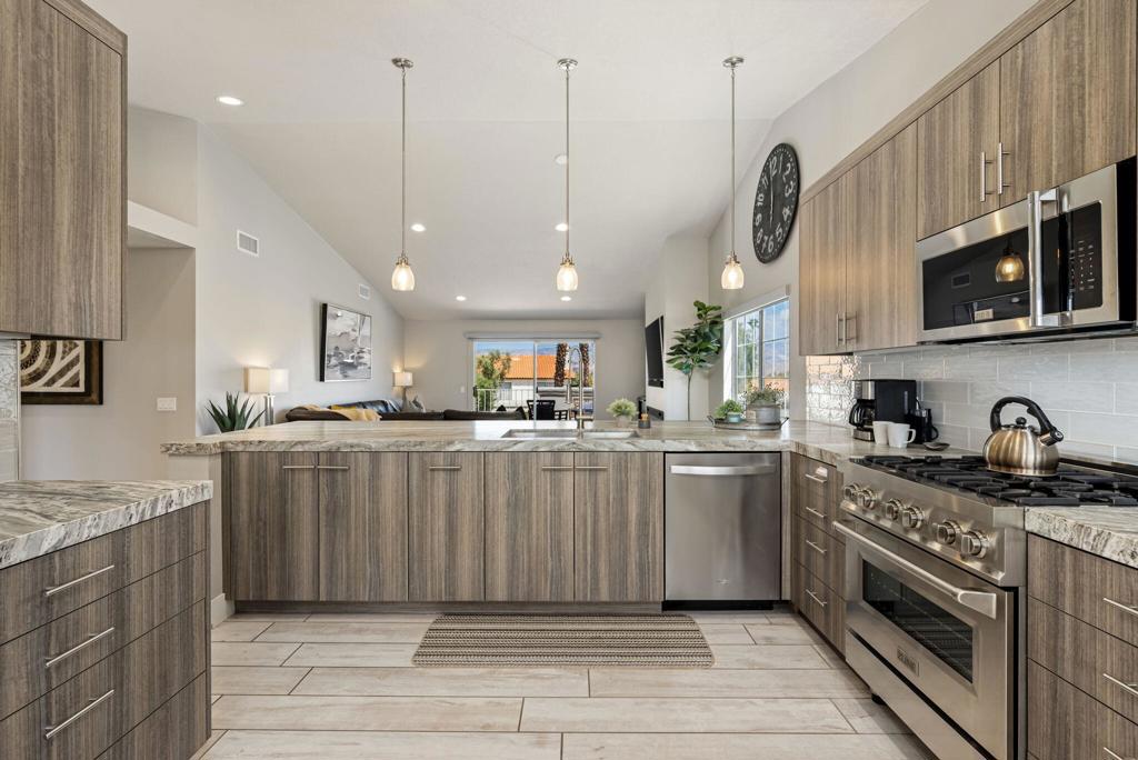 This absolutely beautifully renovated and meticulously maintained, 1814 sq foot, 3bd/2.5 baths, has been totally remodeled! Bright and airy, boasting high cathedral ceilings and open floor plan ideal for entertaining, with a chefs dream designer kitchen, hanging glass light fixtures, designer grade counter tops, custom soft close cabinetry, upgraded stainless appliances, Zline gas range and oven, and extended countertop for prepping, a coffee station, and a sun filled Kitchen Nook with bay windows offering fabulous views. The large, comfy, and tastefully furnished, Living/Dining area with extended Dining Counter Bar is complete with a new electric Fireplace, mounted Flat Screen TV and a recessed Cocktail Bar leading out the slider doors to your Indoor/Outdoor Living Patio with Spectacular Views of the Mountains, Trees and Jr. Olympic Pool! Step into the light bright Primary Suite to enjoy even more commanding views of the mountains with a glass doors opening directly out to the extended back patio, with views of the tapestry textured Chocolate Mountains. The Primary Bath is fit for Royalty with free standing porcelain tub and tiled shower. The bright, and sunny, Ensuite Guest Bed and Bath are beautifully appointed and situated down the hall on other side of the home allowing the 2 Primary Bedrooms space and privacy. The entire home is tiled in luxurious white distressed colonial wood plank porcelain tile flooring consistent with the relaxing palette and overall vibe of this warm clean, calm & relaxing home. Truly the very best of Resort Living with Building and Grounds Maintenance, Tennis, Pickleball, Full Fitness Center, 29+ Pools & Spas, Cable, Wi-Fi, 24hr Gate Guarded, Roving Security and more, all included in your HOA Dues! Golf on Desert Falls Country Clubs 18-hole Scottish Championship Links Course is on a pay as you play basis or choose to opt in on a membership. Desert Falls Country Club has it all! Within walking distance to restaurants & shopping, and just a few miles drive to Acrisure Arena, McCallum Theatre and El Paseo with upscale shopping, Designer Boutiques, Galleries and Fine Dining. Uniquely renovated, with its multitude of upgrades, this home is turnkey furnished and move in ready for Season! Excellent Rental History, with bookings in place for Jan, Feb & March 2026. Short Term leasing currently allowed. MUST SEE to Truly appreciate quality and workmanship! Call today for your private tour!