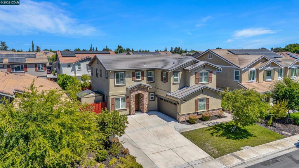 Like-New 2019 Build in Duarte Ranch Estates! This beautifully maintained 5-bedroom, 3-bath home offers 2,753 sq ft of comfort and style with a spacious, light-filled floorplan. Gorgeous laminate flooring flows throughout, creating a warm, inviting feel. The gourmet kitchen boasts an oversized island perfect for family gatherings, while the open living and dining areas make entertaining effortless. Upstairs features 4 bedrooms, a laundry room, and a versatile loft—ideal for work or play. The primary suite offers a relaxing sunk-in tub, dual sinks, and a generous walk-in closet. Outdoors, enjoy a built-in gas fire pit, BBQ island, pergola, stamped concrete patio, and large shed for storage—your own private retreat. Additional highlights include a Tesla charging station, epoxy garage floor, extended driveway, and nearby community park. Conveniently located approx. 2.5 miles to Hwy 4, minutes to Antioch BART, and near the upcoming Safeway-anchored shopping center with up to 73 EV stations. Pride of ownership throughout!