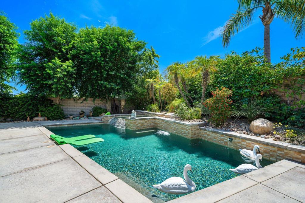 Welcome to Whitehawk, one of Palm Desert's most beloved gated communities, where wide, palm-lined streets and a warm neighborhood feel set the tone for desert living. This stunning south-facing, corner-lot home is more than just a residence--it's a place designed for gathering, entertaining, and creating memories.Step through the private courtyard and into a home that immediately feels like home. Soaring ceilings, walls of glass, and an open flow connect the living and dining spaces, inviting you to relax by the cozy fireplace surrounded by stacked rock, or enjoy the heart of the home--the gourmet kitchen. With granite countertops, stainless appliances, and a large island that opens into the great room, it's the perfect space to cook, host, and share stories over good food and wine.With four bedrooms plus a bonus room with its own private entrance, this home offers incredible flexibility--whether you want a home office, guest retreat, or creative studio. The primary suite is your personal sanctuary, complete with a spa-like bath, oversized walk-in closet, and direct views to the backyard.Set on a prime corner lot in Whitehawk, it feels like your own private resort. Fruit trees, lush landscaping, a patio cover, and a sparkling saltwater pool and spa create a tropical oasis where afternoons turn into unforgettable evenings. Fire up the built-in grill, pour a glass of something cold, and watch the desert sunset paint the sky.This home is as practical as it is beautiful, with thoughtful updates including new flooring, baseboards, freshly painted cabinetry, updated lighting in baths, a brand-new 2025 water heater, pool pump and saltwater system, solar system, and a spacious garage with extra storage.Life in Whitehawk is relaxed yet connected, with one of the lowest HOA dues in the valley (just $200/month, including cable and WiFi). Golfers and social seekers alike can take advantage of Woodhaven Country Club, offering public golf, membership for tennis, fitness, dining, and spa access--all without the cost of living directly on the course.With top-rated schools nearby and shopping, dining, and entertainment just minutes away, this is more than a home--it's the lifestyle you've been waiting for.