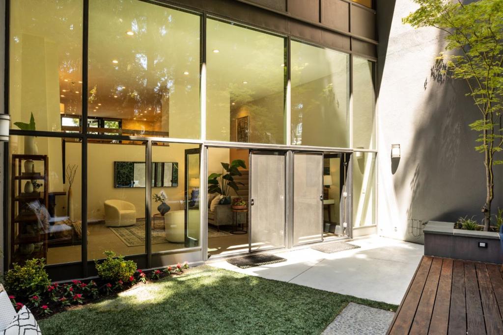 Mid-Century Warmth Meets Urban Sophistication in Menlo Parks' Park Forest Neighborhood! Floor-to-ceiling windows, sleek renovations, and a rare sense of privacy define this stylish move-in ready home nestled beneath majestic oaks and whispering redwoods. Enjoy all recent finishes including windows, doors, floors and walls. More than adequate storage space is offered in the livable garage with wall-to-wall modern cabinetry and an epoxied floor. Thoughtfully designed for indoor-outdoor living, the home features two spacious balconies, a redwood grove beyond the patio, and a stunning rear garden designed by an award-winning landscape architect. Enjoy access to a community pool, award-winning Menlo Park schools, and walkability to the new Springline development with hotspots like Che Fico, Burma Love, and Barebottle Brewing Co. Stroll to Holbrook-Palmer Park, Atherton Library, or simply relax in your forest sanctuary. Timeless design meets unbeatable location.